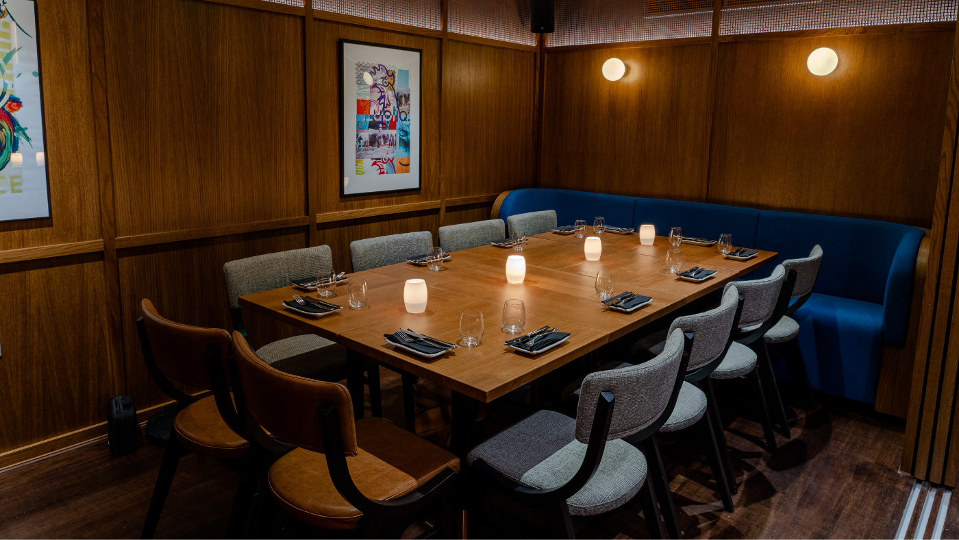 Dining room at Publiq with wood-panelled walls and one big table 