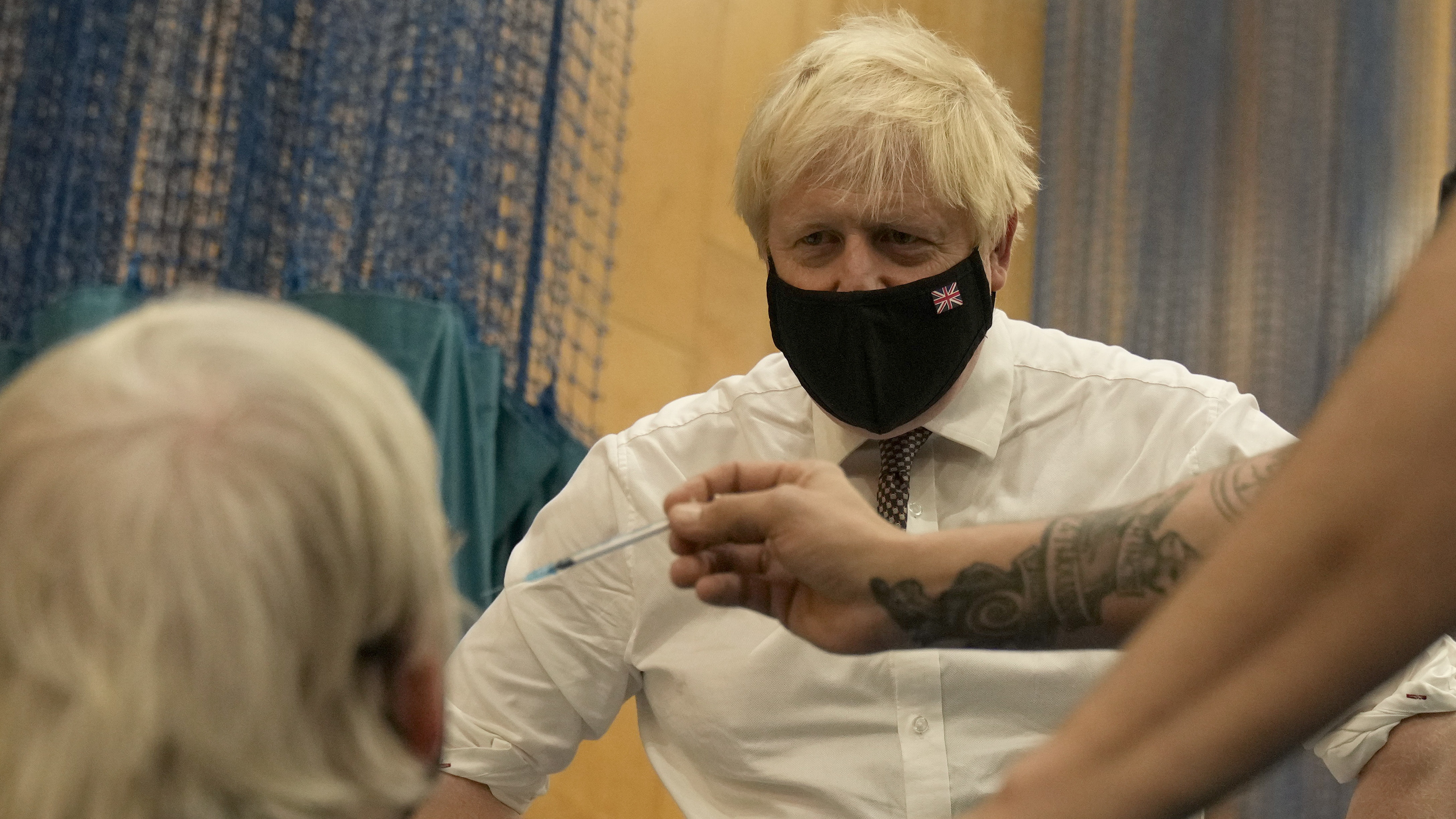 Boris Johnson watches as a booster jab is administered in Little Venice, London