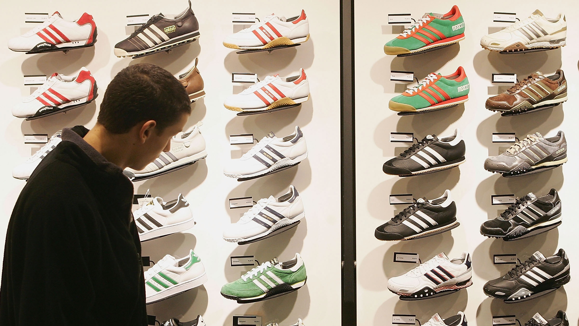 A man looks at Adidas shoes