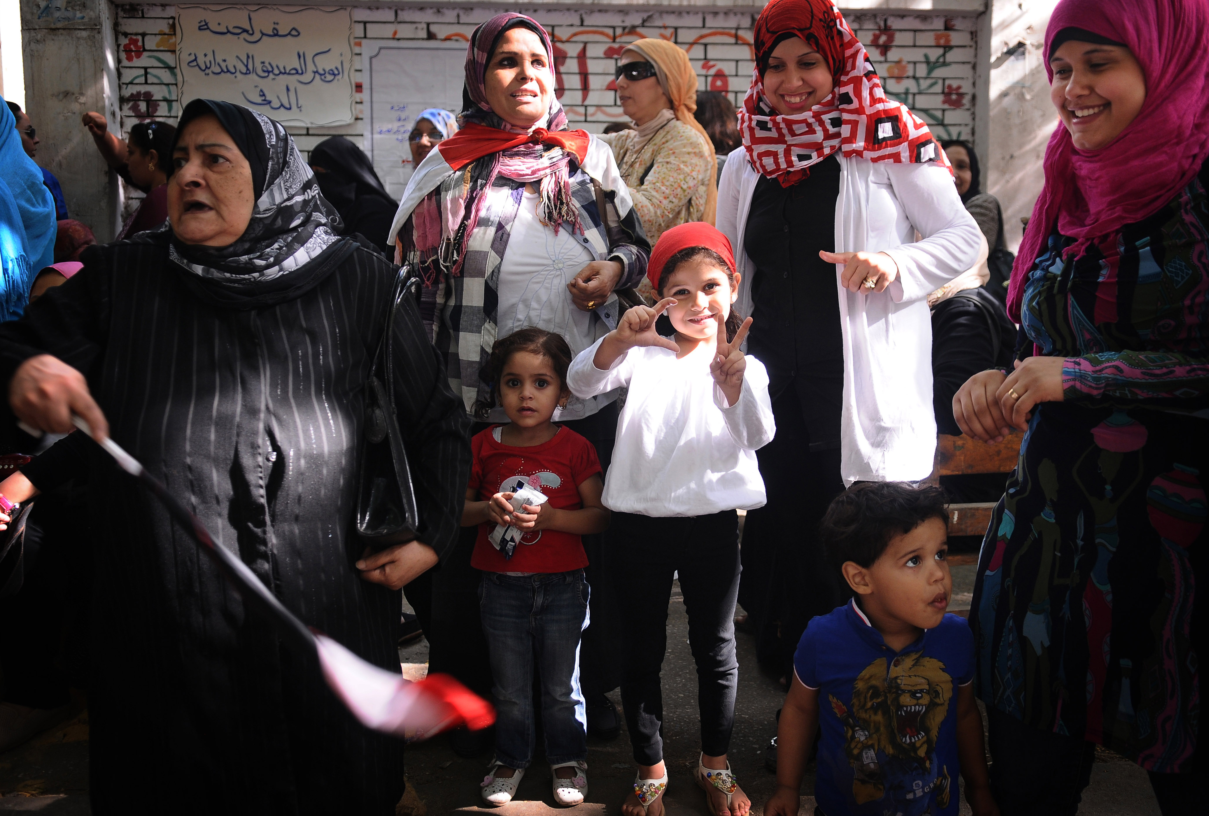 Egyptians wait in line to vote at a polling station in Cairo