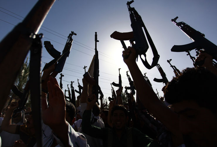 Militants brandish their weapons in Iraq