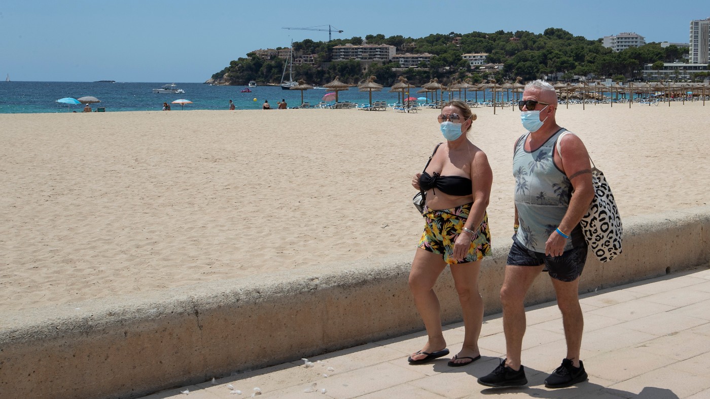 Holidaymakers on a beach in Spain