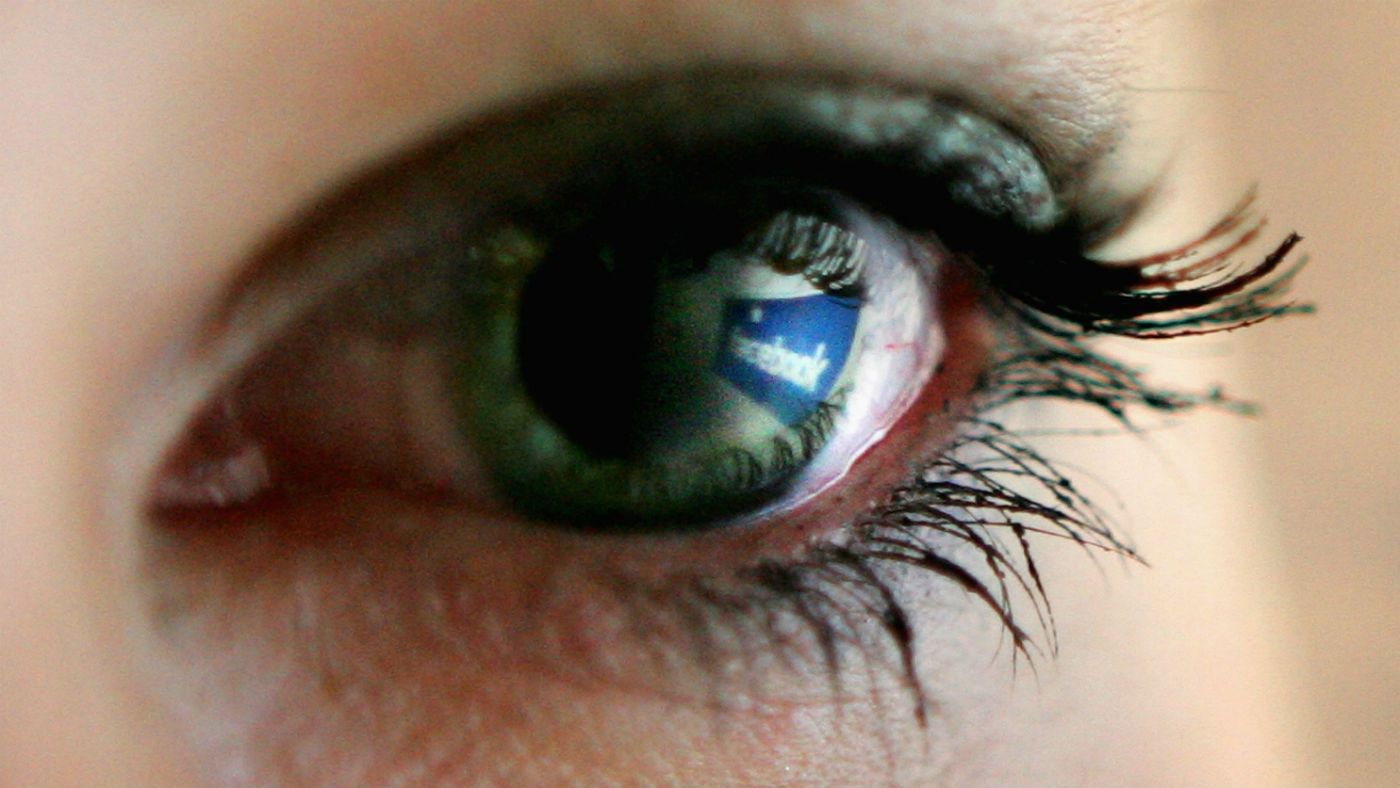 Facebook logo reflected in an eye