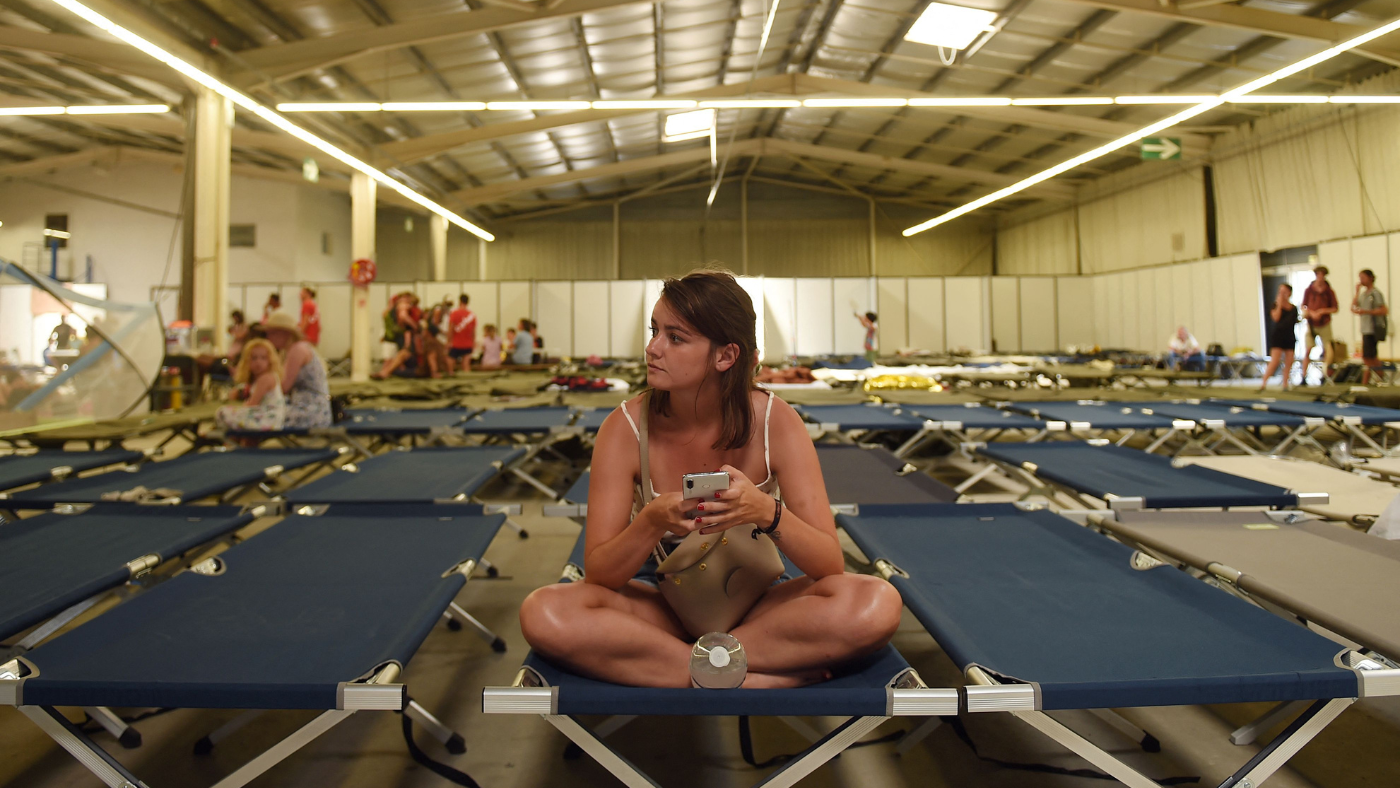 Woman sits in evacuation shelter