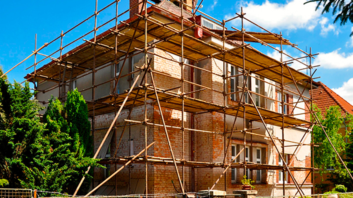 A large house surrounded by scaffolding