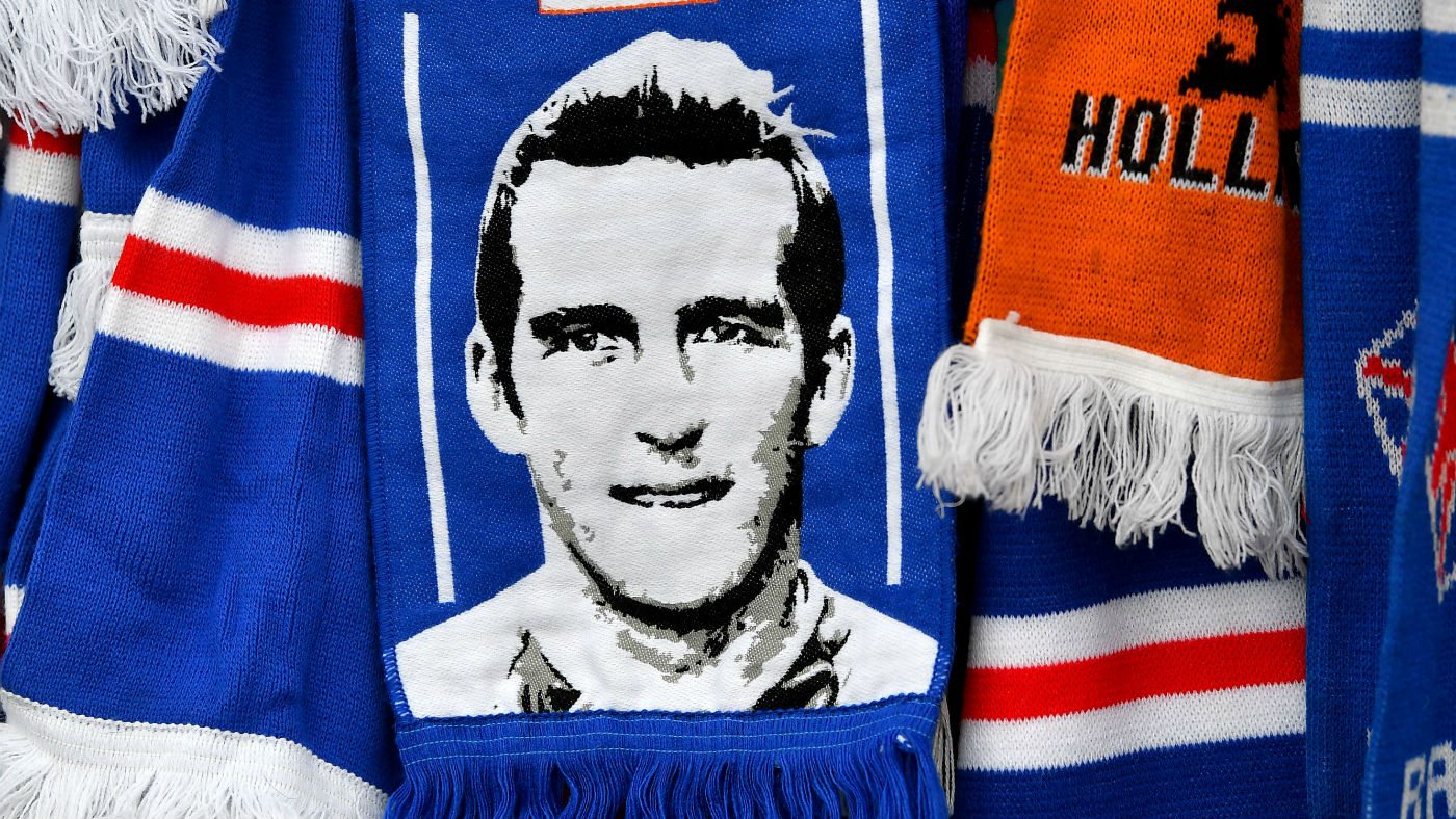 Rangers fans pay tribute to Fernando Ricksen by leaving scarves and flowers at the gates of Ibrox Stadium 