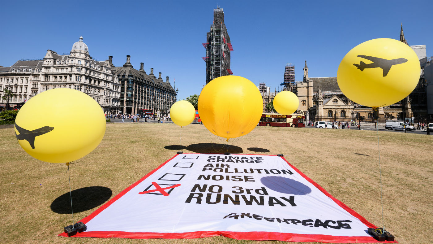 A Greenpeace protest against a third runway takes place outside Parliament on Monday