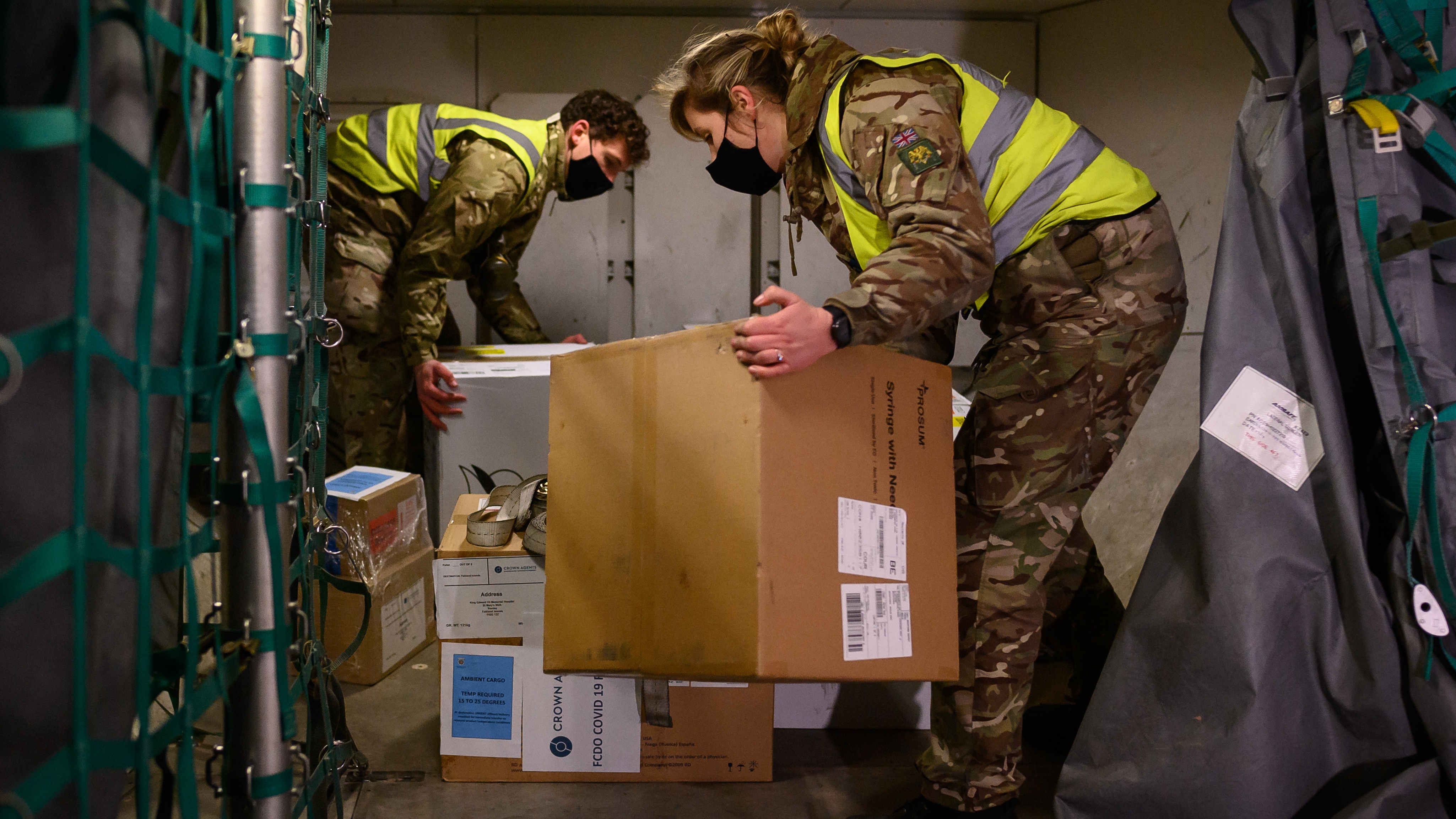 RAF personnel load a batch of the Covid-19 vaccine onto an aircraft