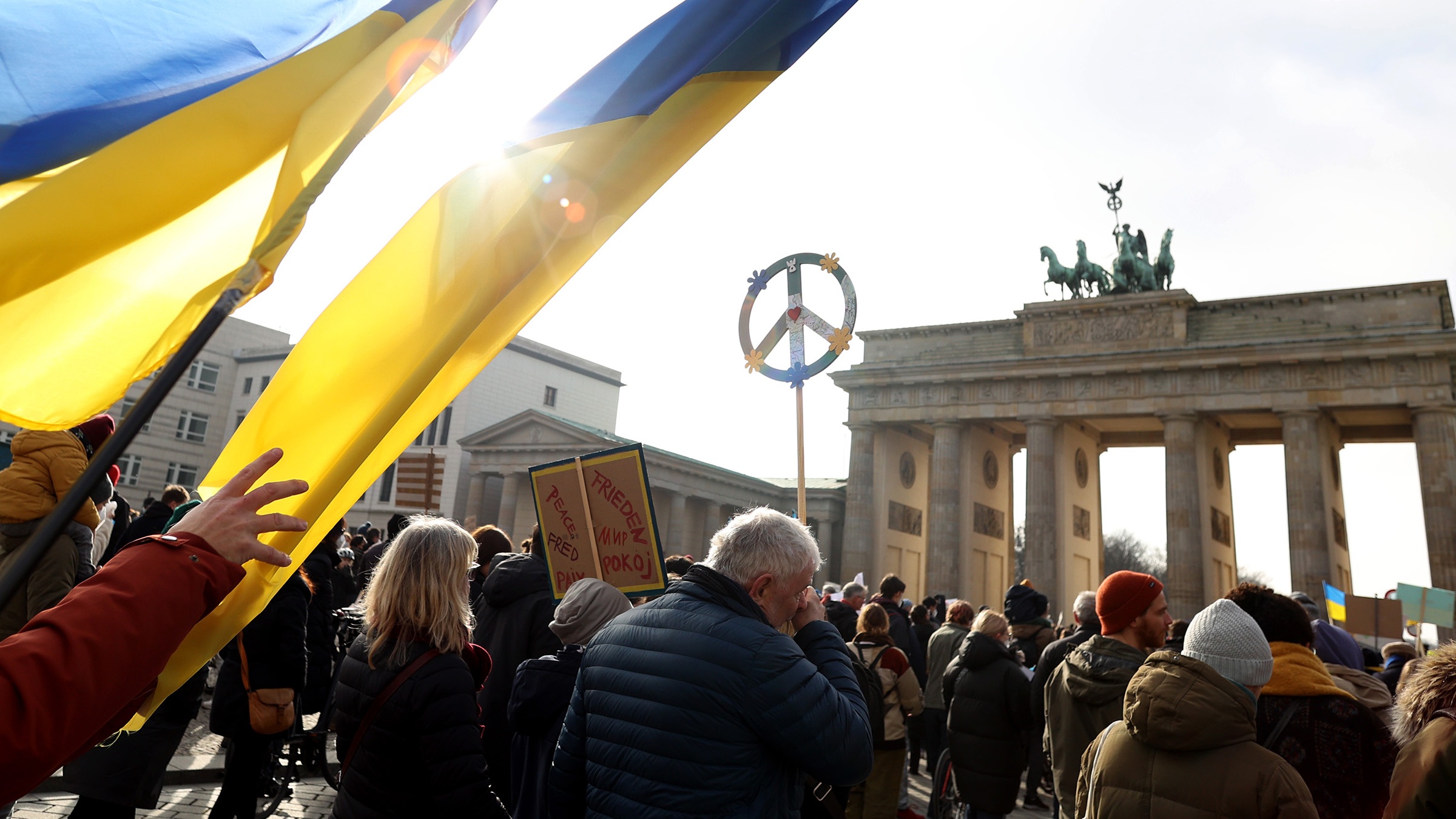 Anti-war protesters march near the Brandenburg Gate in Berlin