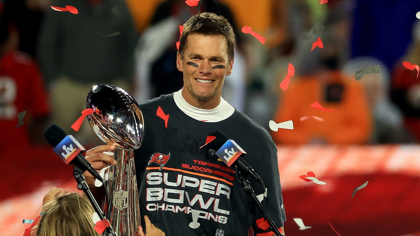 Tampa Bay Buccaneers quarterback Tom Brady lifts the Vince Lombardi Trophy after winning Super Bowl LV  