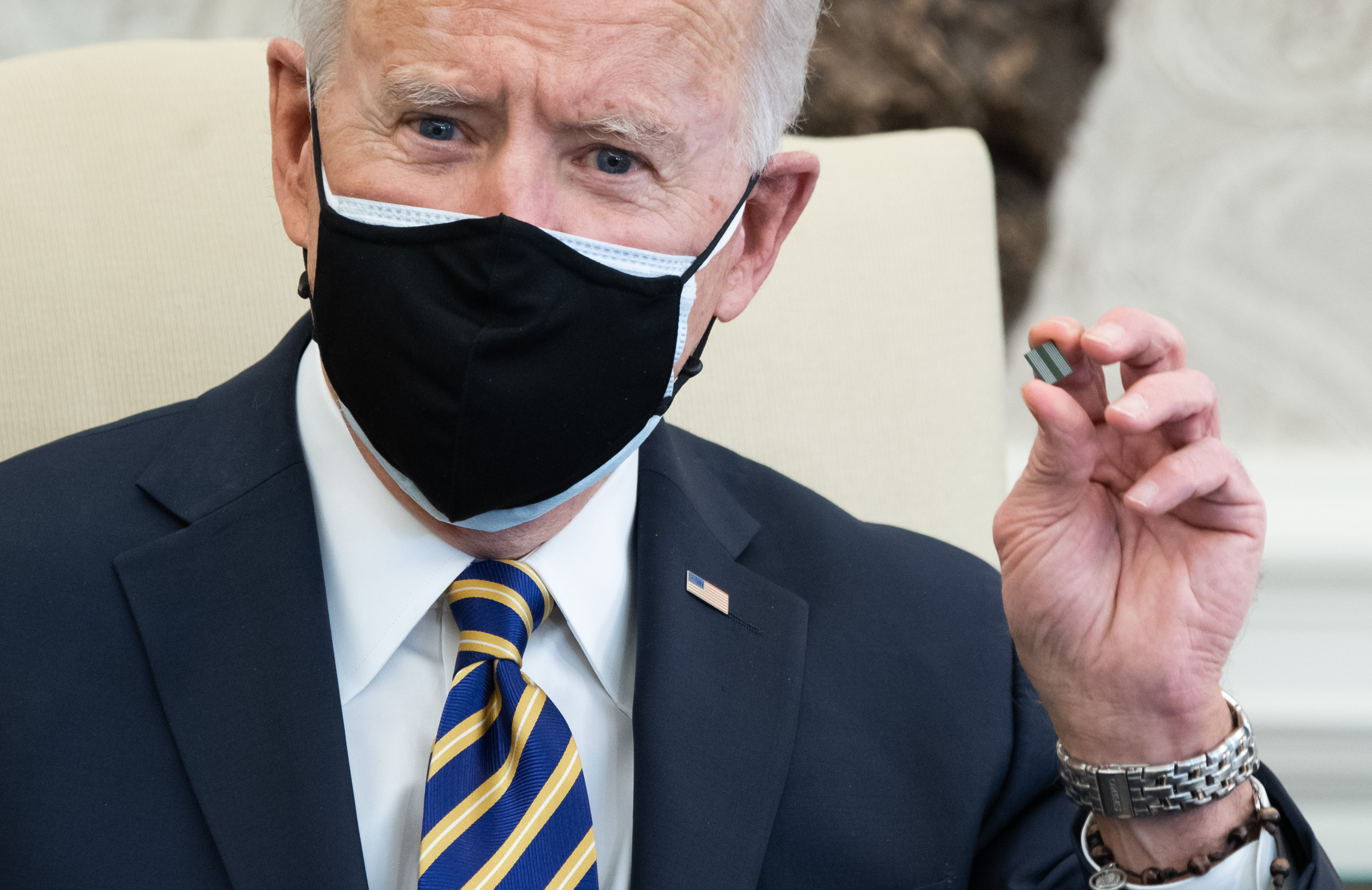 Joe Biden holds up a microchip 