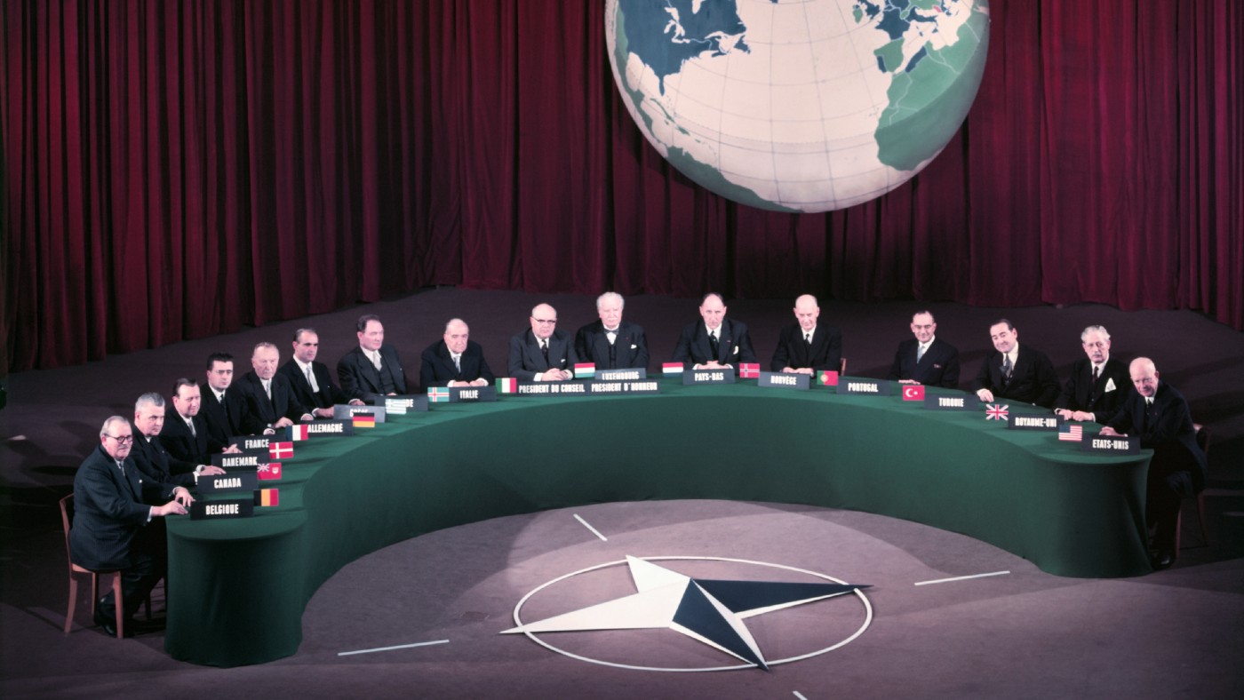 Long table of men at Nato summit