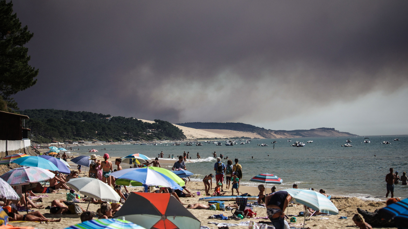 Beach under black smoke cloud