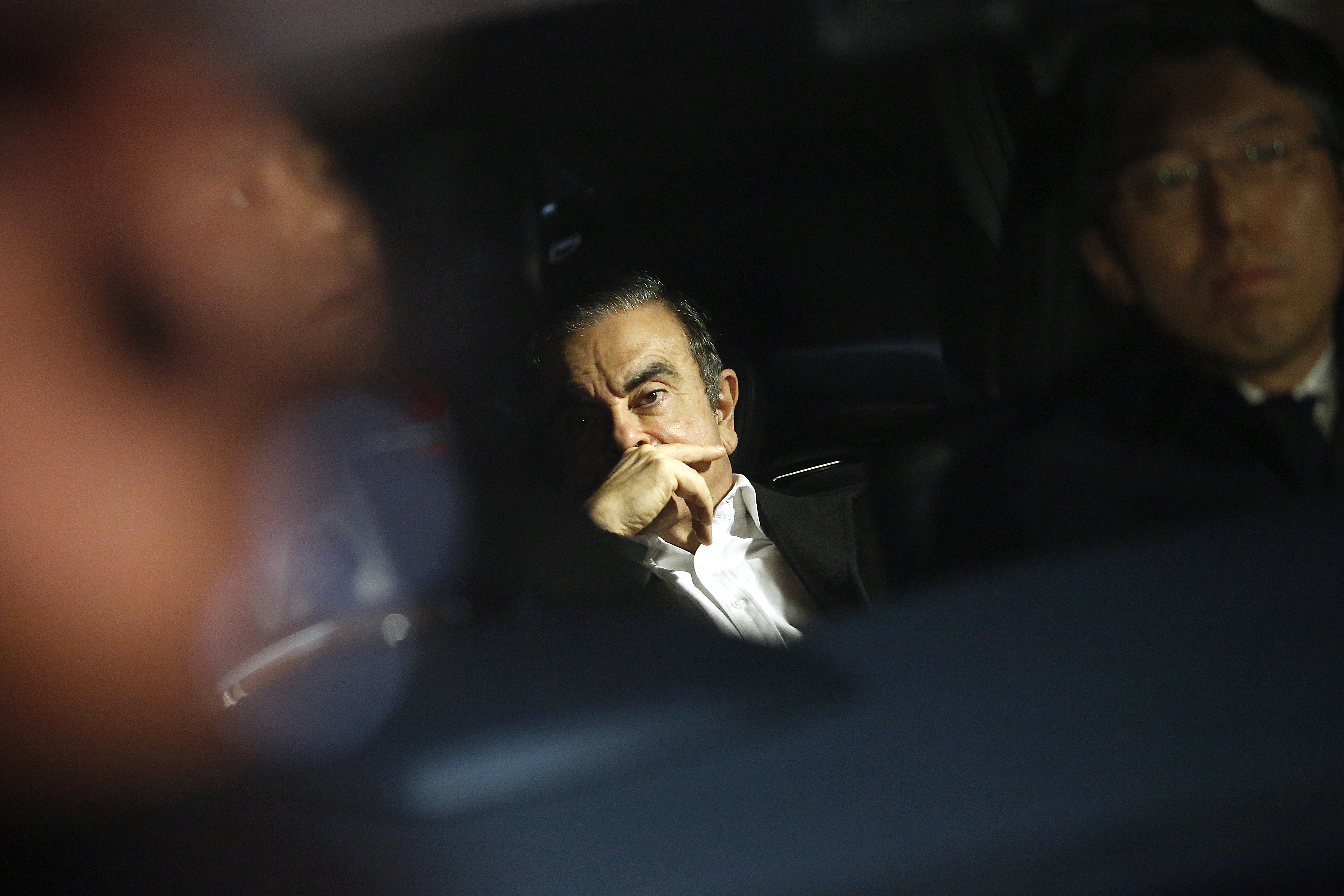 Bloomberg Best of the Year 2019: Carlos Ghosn, former chairman of Nissan Motor Co., center, sits in a vehicle as he leaves his lawyer&#039;s office in Tokyo, Japan, on Wednesday, March 6, 2019. Ph
