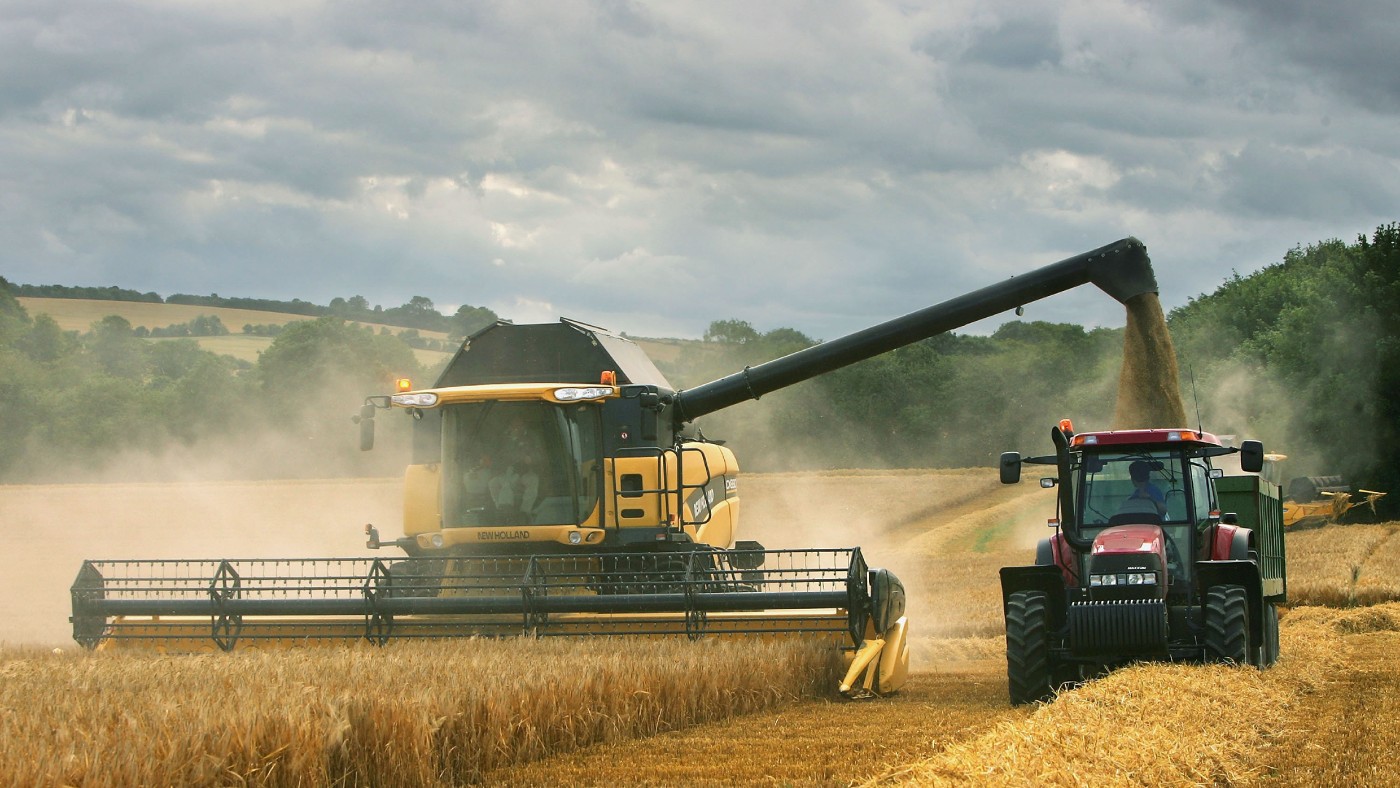 A combine harvester works its way through a field of barley 