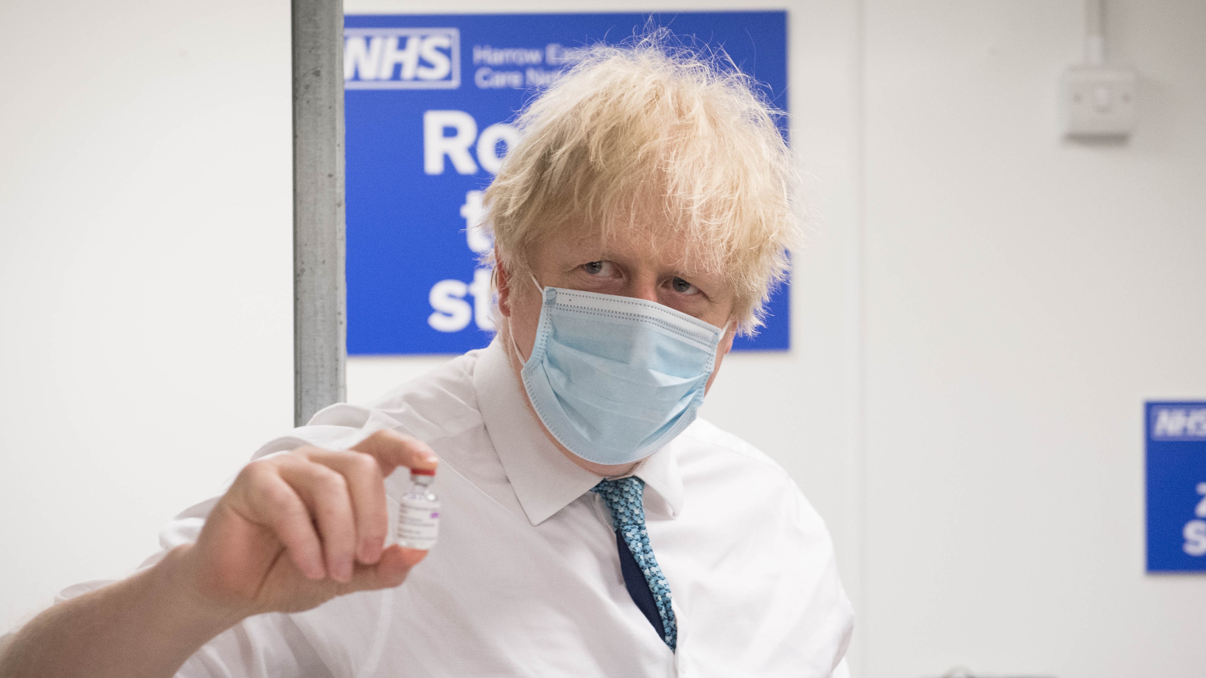 Boris Johnson poses with a vial of the Oxford-AstraZeneca vaccine