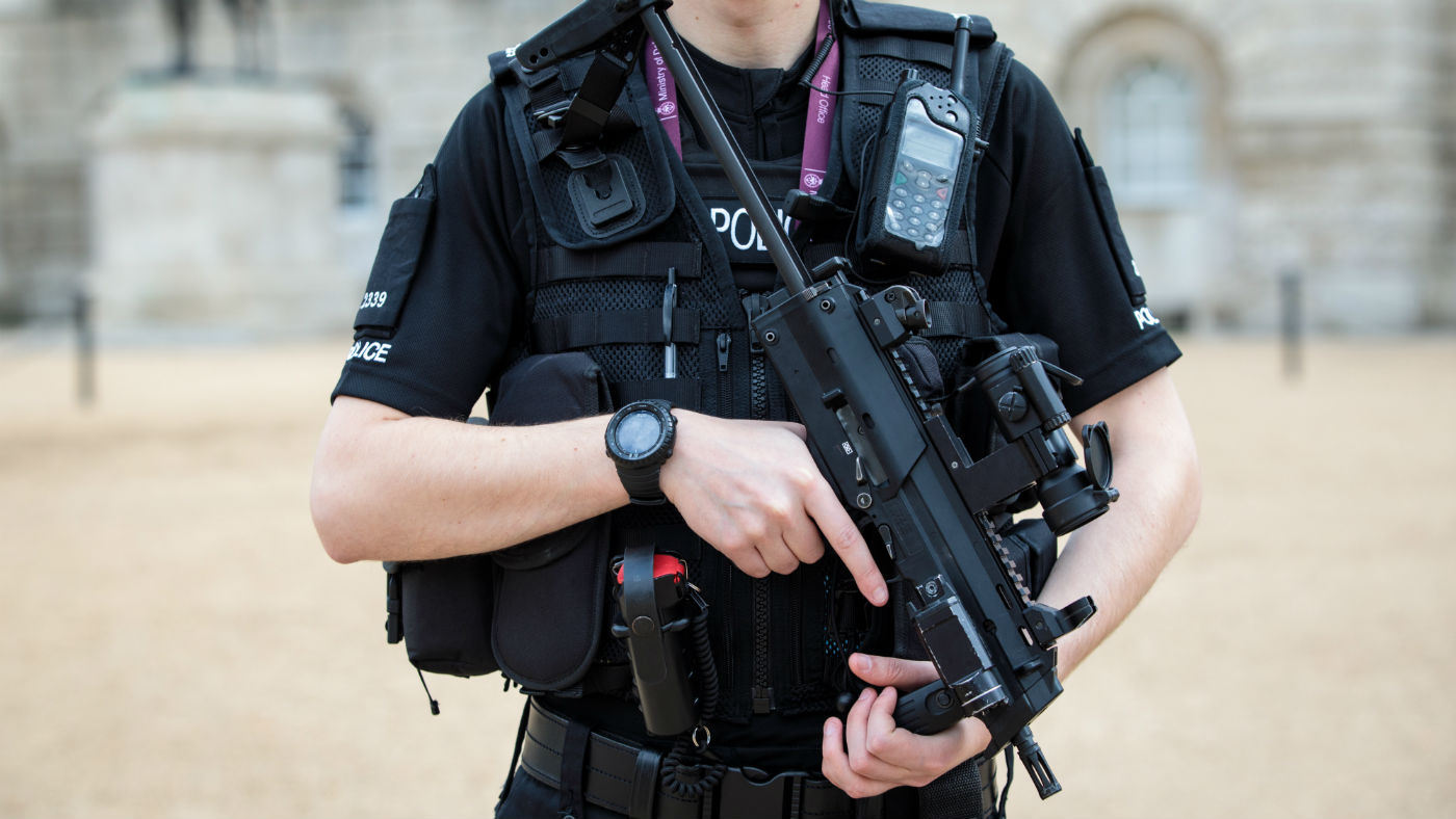 An armed police officer patrols in Horse Guards Parade in London 