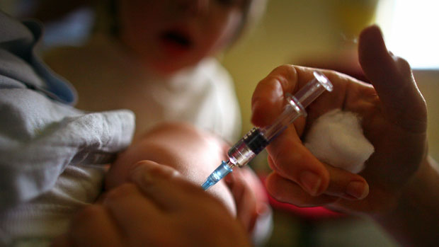Young child receives vaccination at a health centre 