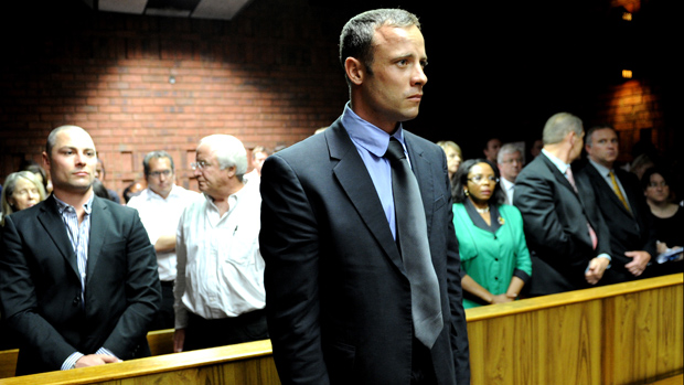 South African Olympic sprinter Oscar Pistorius (C) appears on February 19, 2013 at the Magistrate Court in Pretoria as he father Henke (3rd L), brother Carl (2nd L) and sister Aimee (L) atten