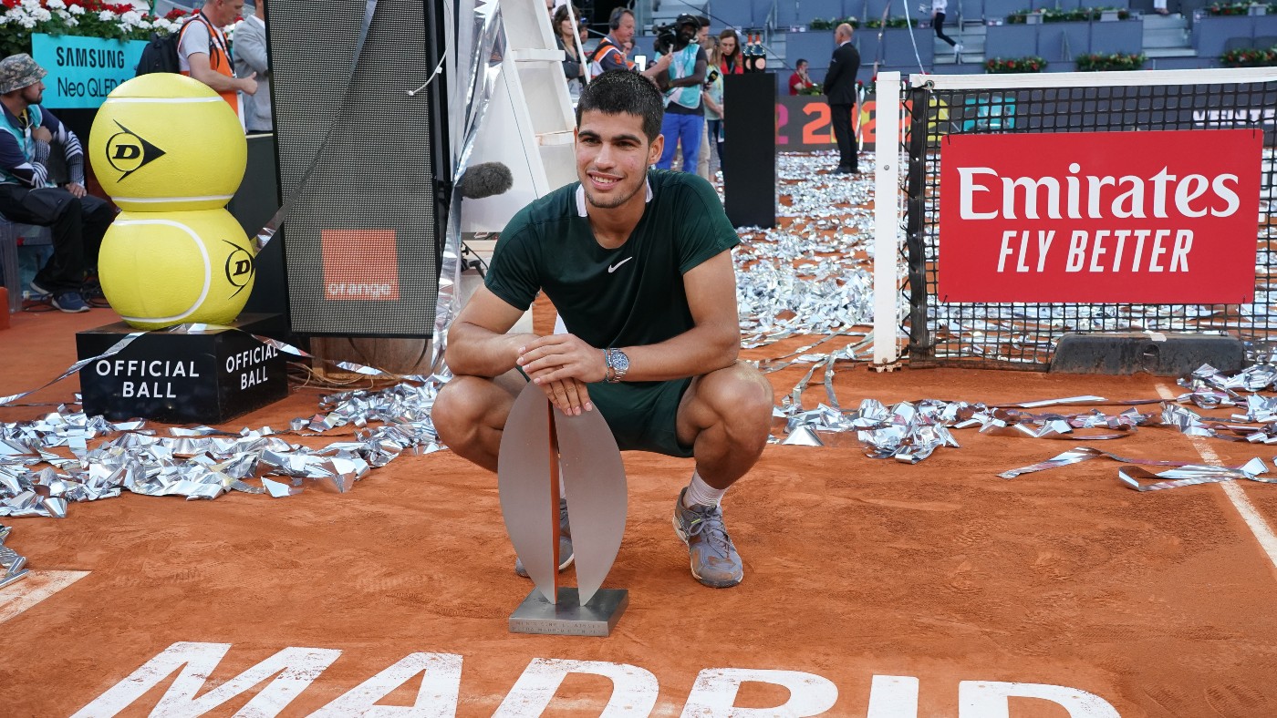Carlos Alcaraz poses with the trophy at the Madrid Open