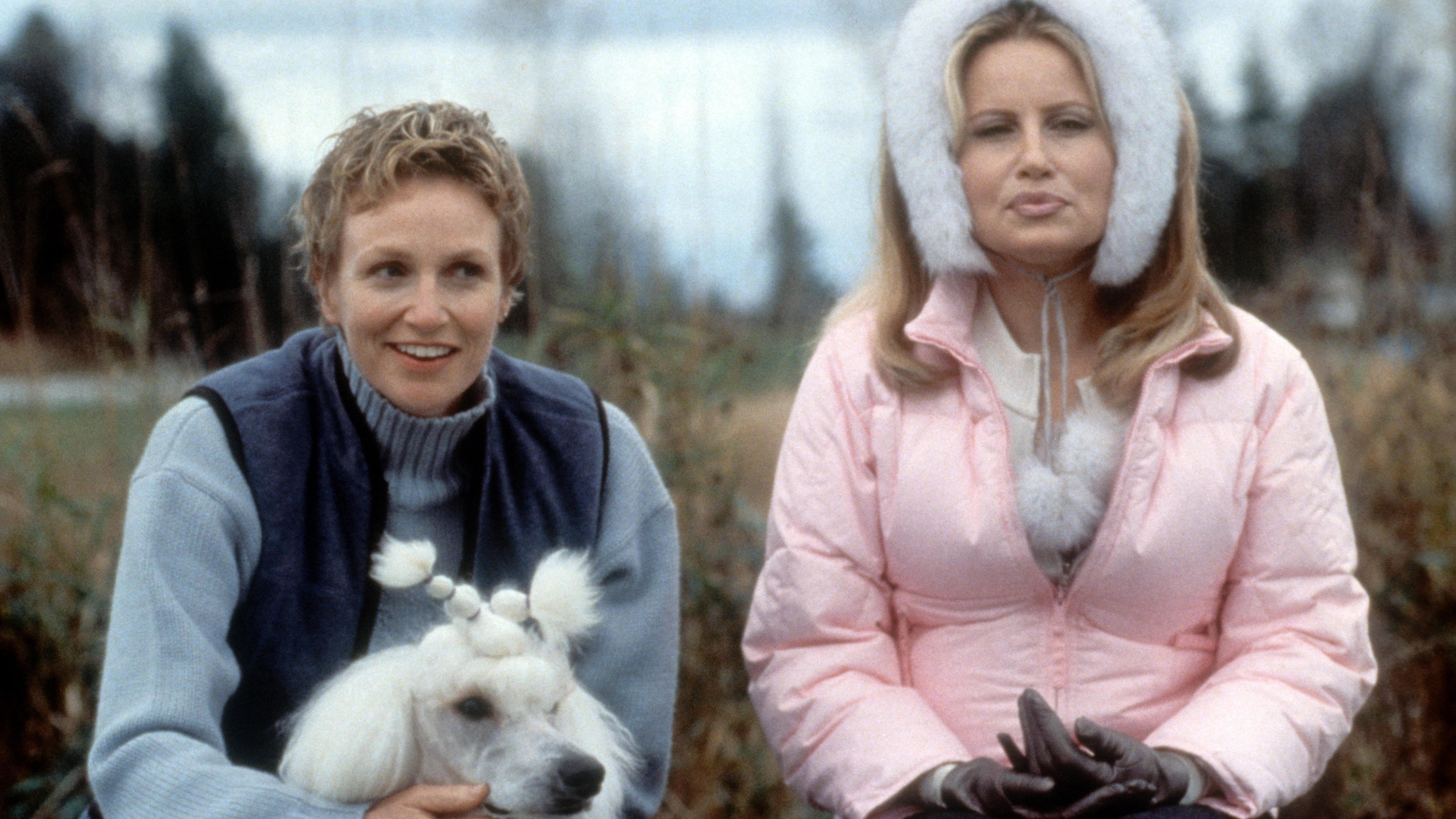Coolidge in pink jacket and white fluffy earmuffs on the pretty and Carrie Aizley in a blue vest with poodle on the left