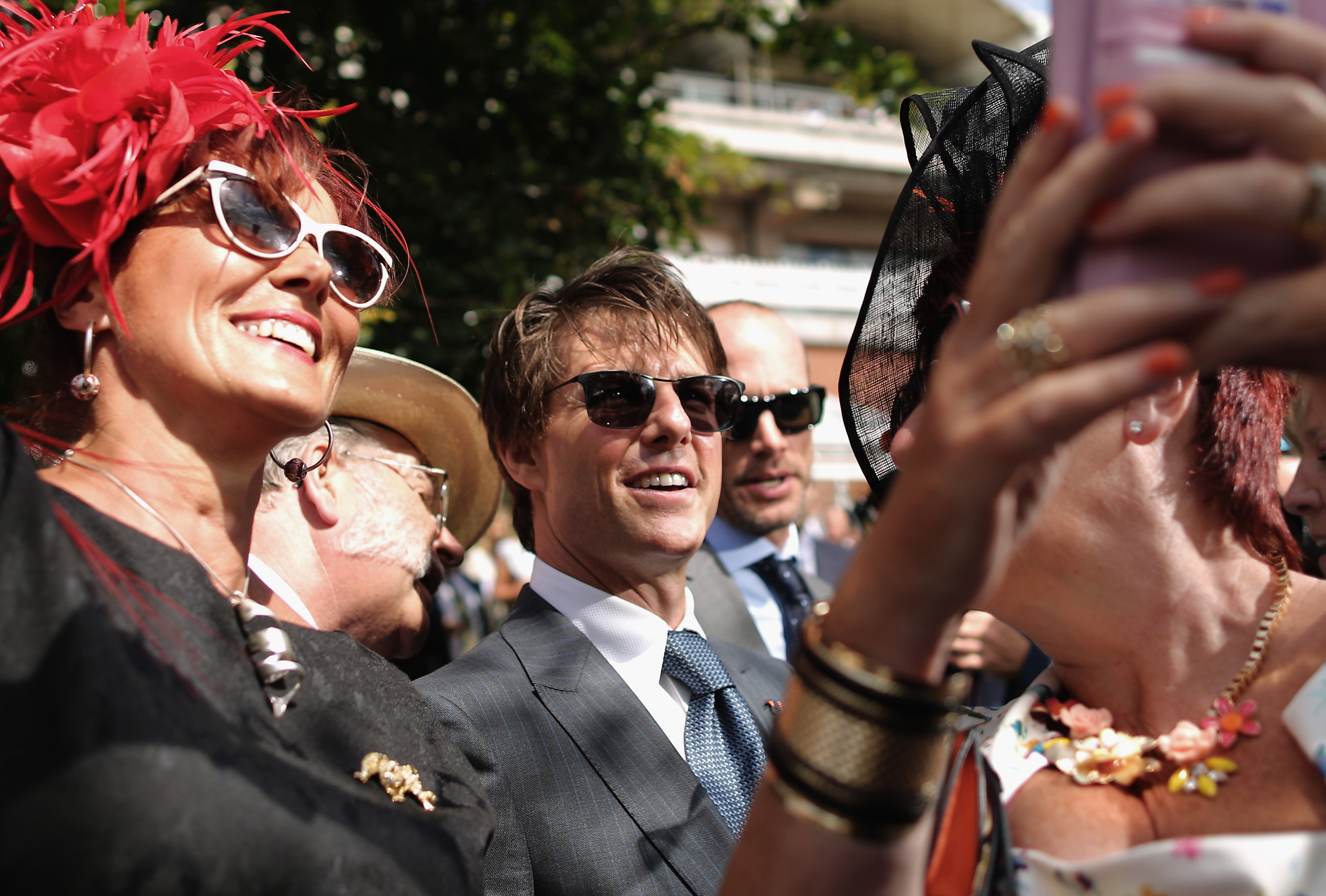 Women take selfies with actor Tom Cruise on Ladies Day at Goodwood Races