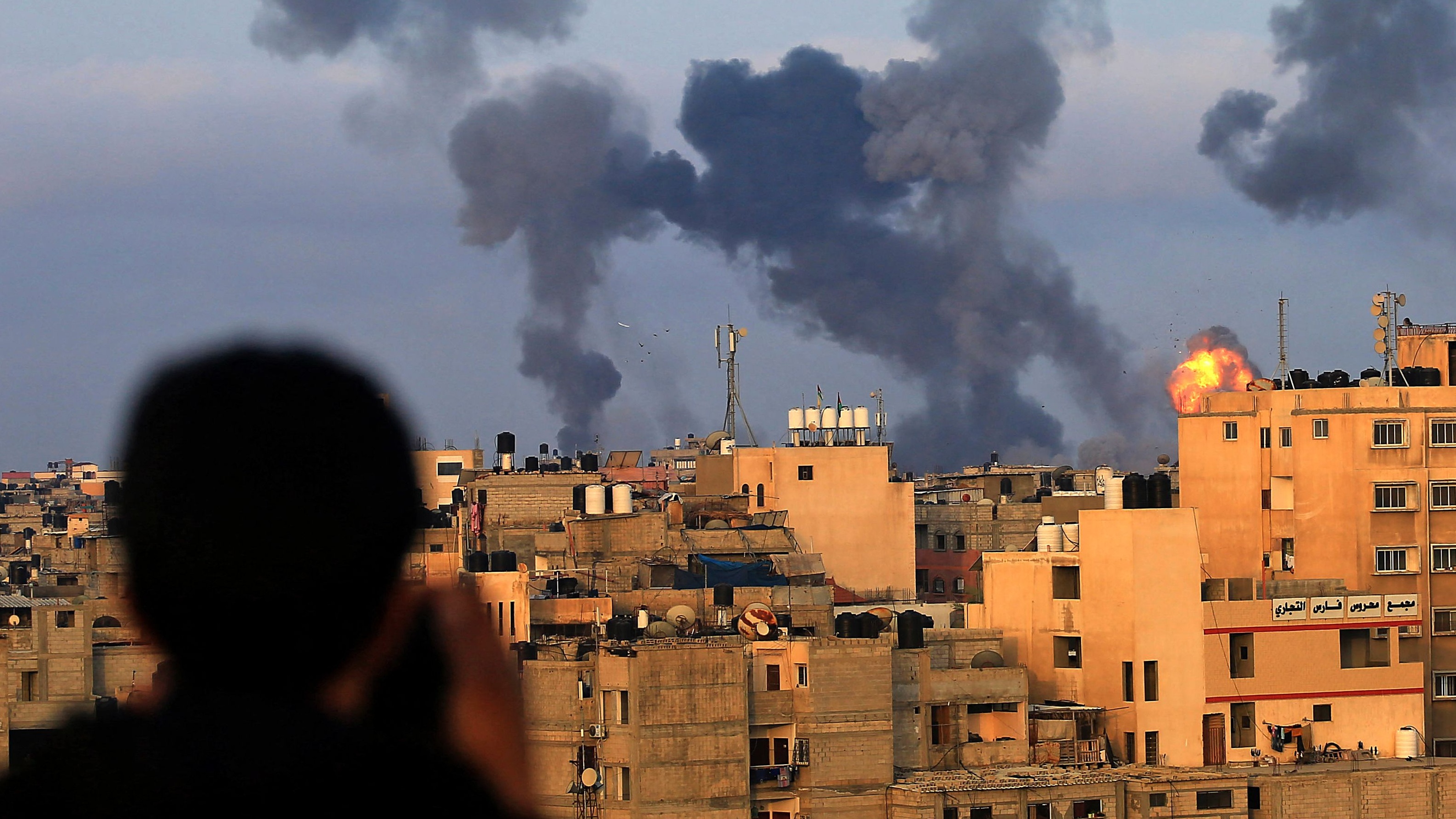 A Palestinian boy watches as Israeli airstrikes hit the southern Gaza region of Khan Yunis