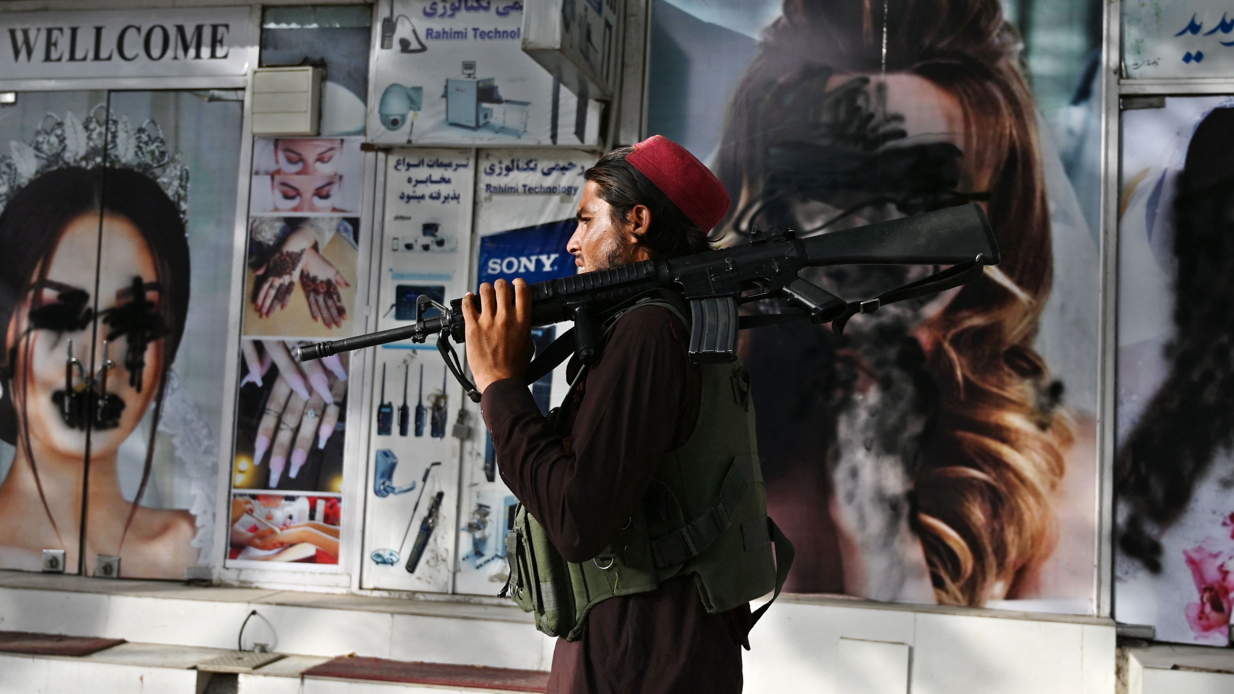 A Taliban fighter walks through central Kabul