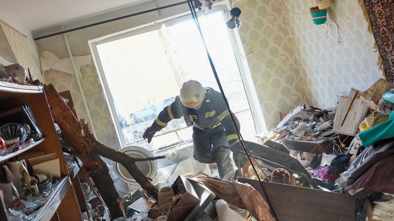 24 February: Ukrainian firefighters arrive to rescue civilians after an air strike on an apartment complex outside Kharkiv, Ukraine’s second largest city