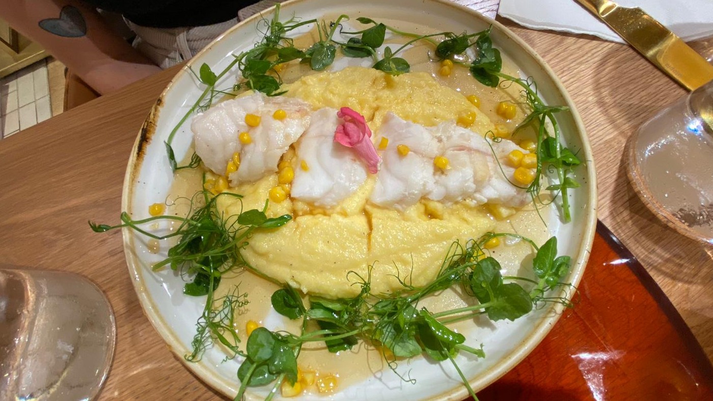 Monkfish served on a bed of salad leaves, polenta, cheese and corn