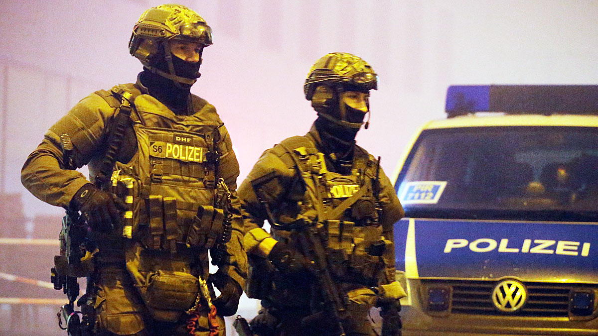 Police stand guard after the attack at a Munich shopping centre