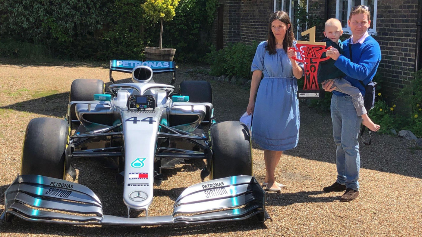 Harry Shaw with his parents James and Charlotte outside their home with the Mercedes F1 car 