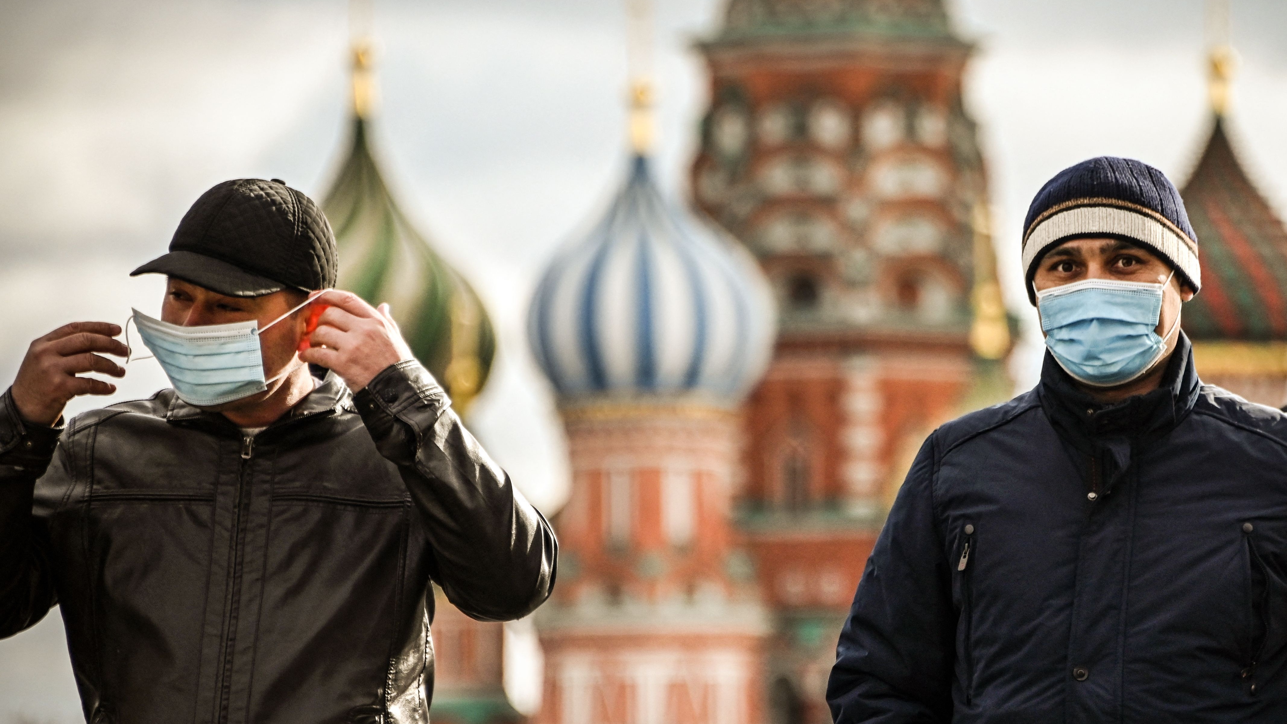 Tourists wearing face masks walk through Red Square, Moscow