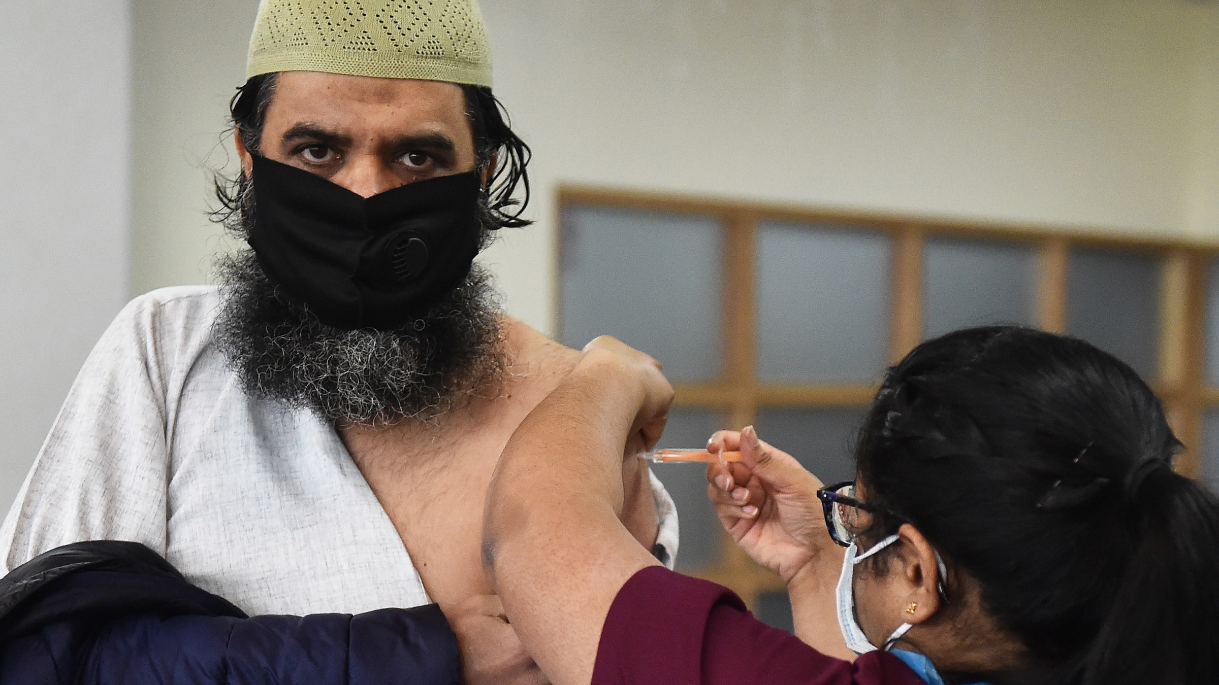 A man gets vaccinated at City Central Mosque in Stoke