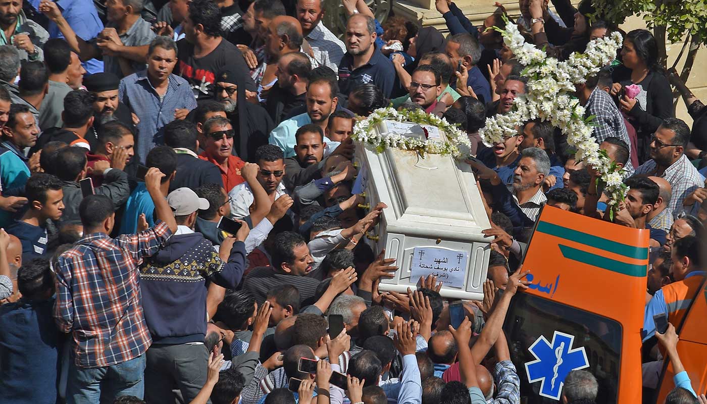 Mourners carry the coffin of one of seven Christians killed in Egypt on Friday