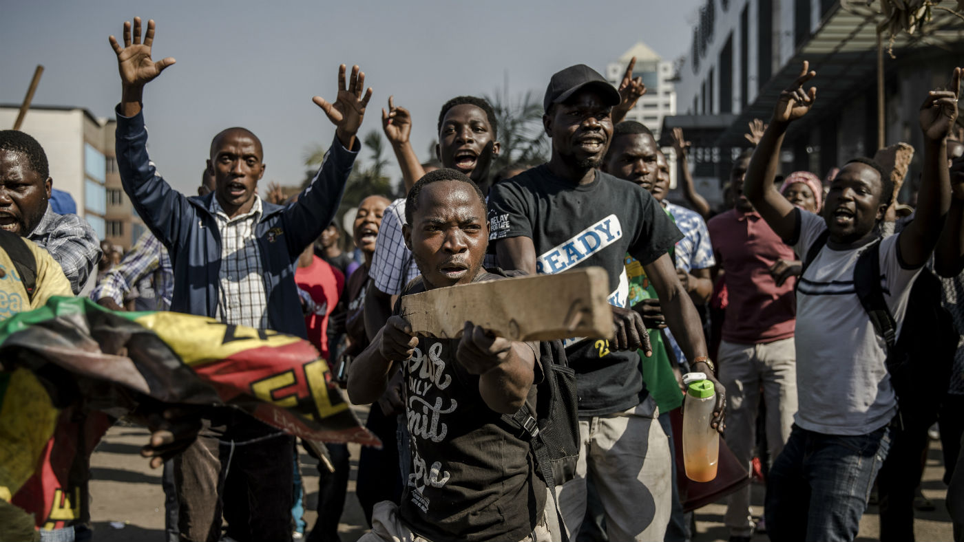 Supporters of  MDC Alliance take part in a protest in Harare at alleged election rigging