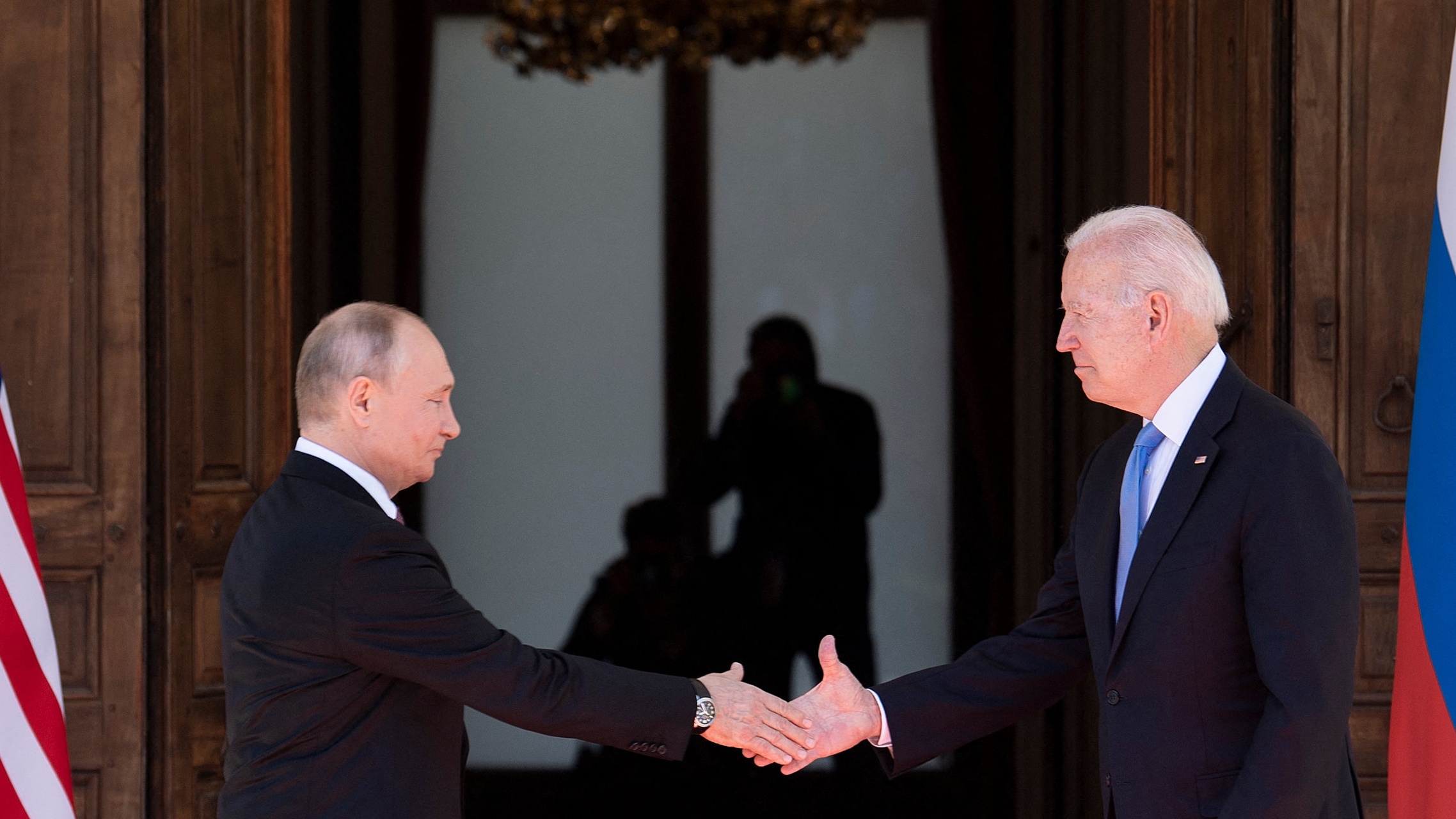 Vladimir Putin and Joe Biden shake hands ahead of a summit in Geneva, Switzerland in June
