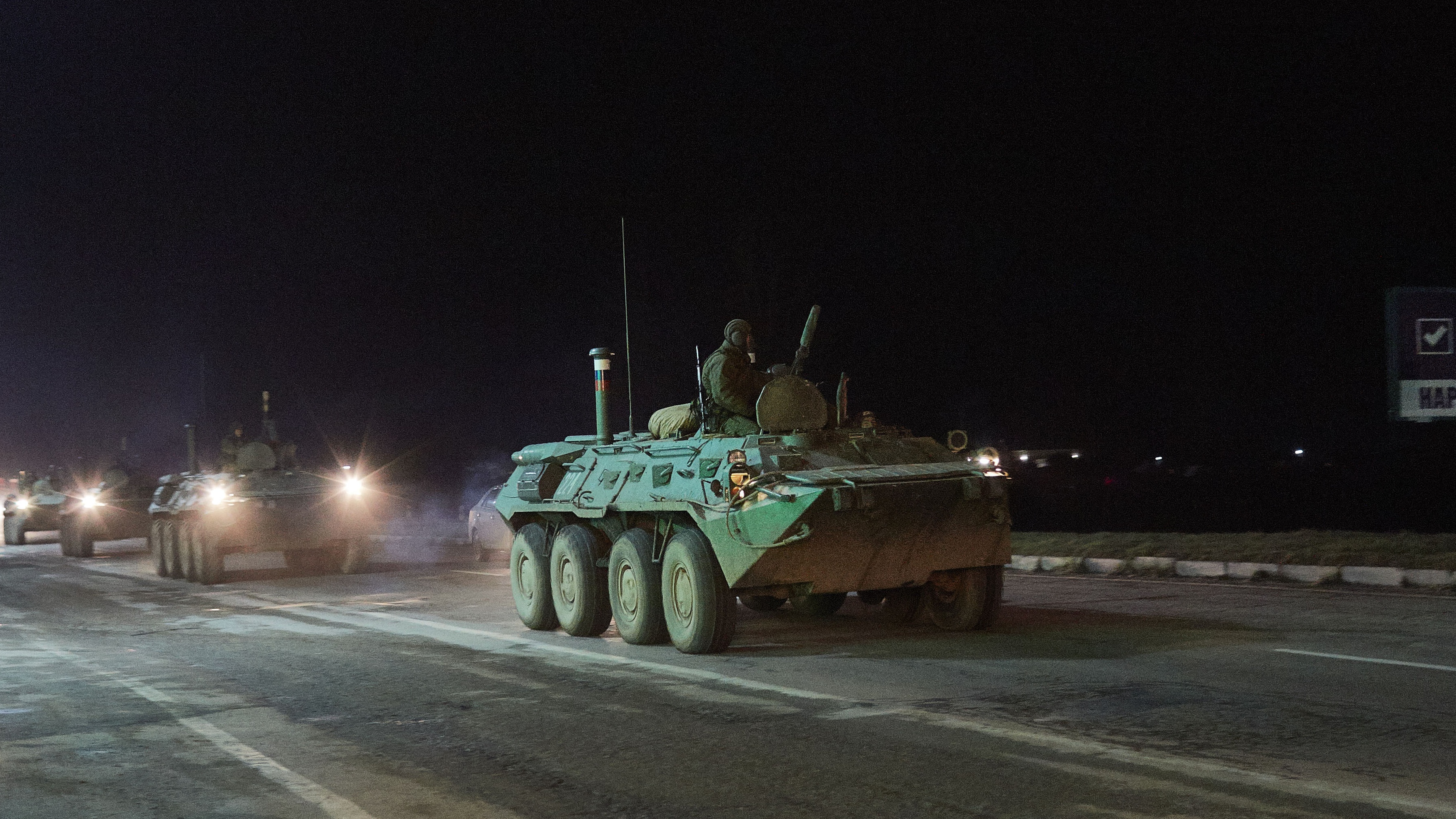 A large column of Russian military vehicles and troops move in the direction of the Crimean capital of Simferopol in February 2014 