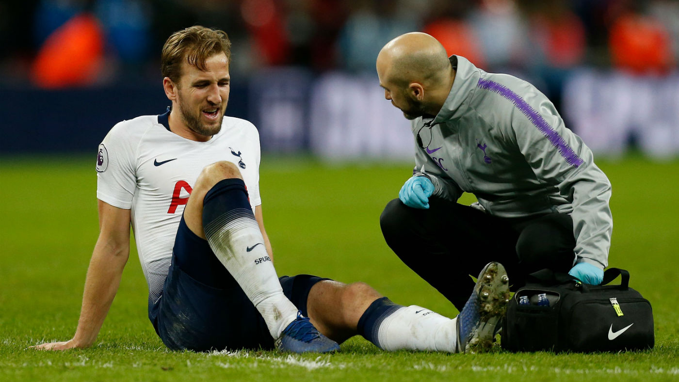 Tottenham Hotspur striker Harry Kane receives treatment for his injured ankle