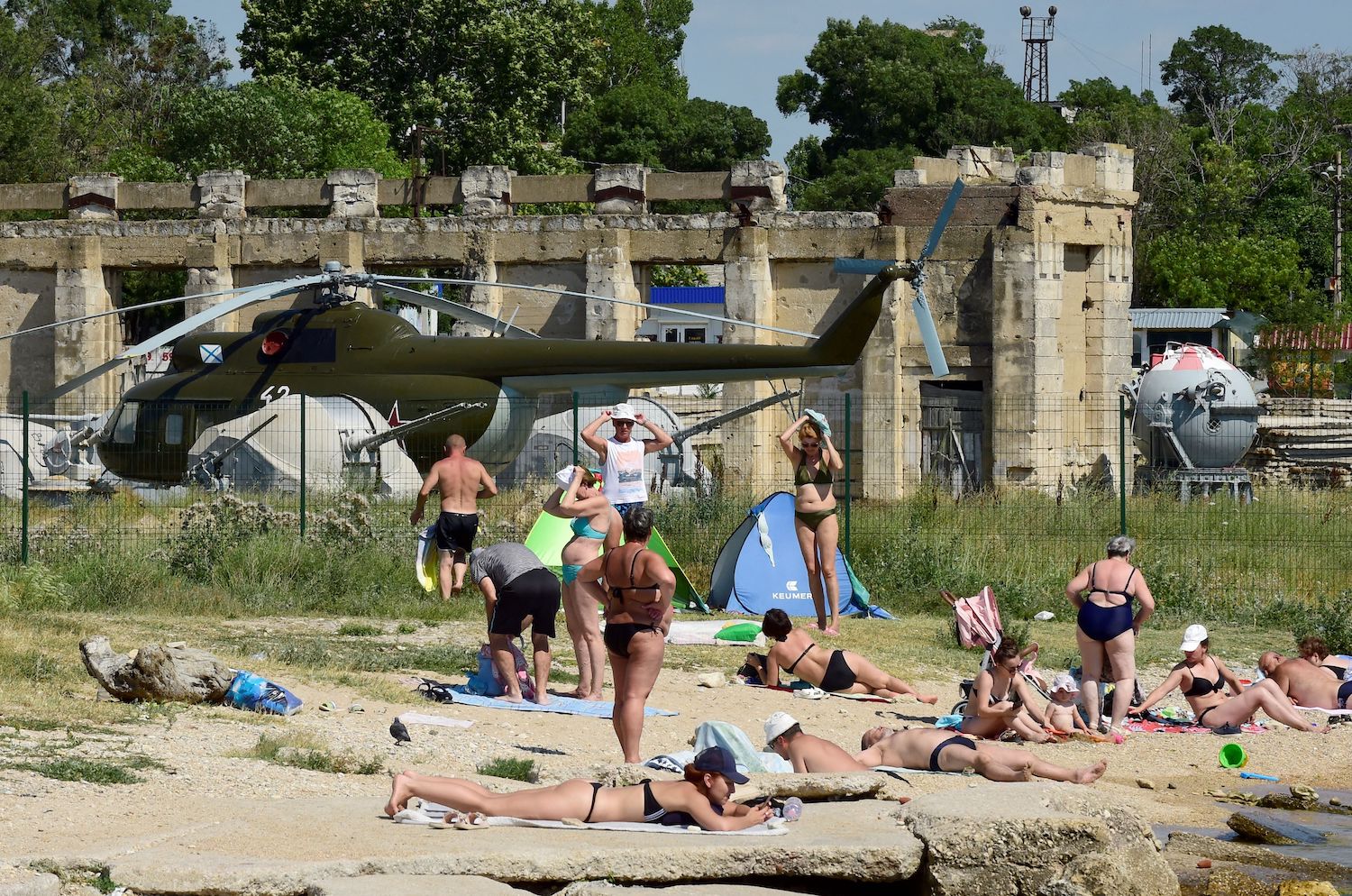 Tourists on beach by Russian airbase in Crimea