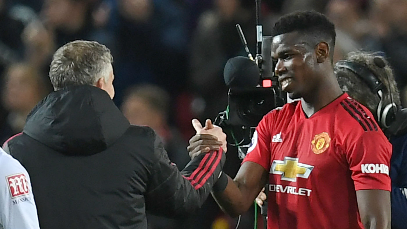 Manchester United caretaker manager Ole Gunnar Solskjaer shakes hands with Paul Pogba 