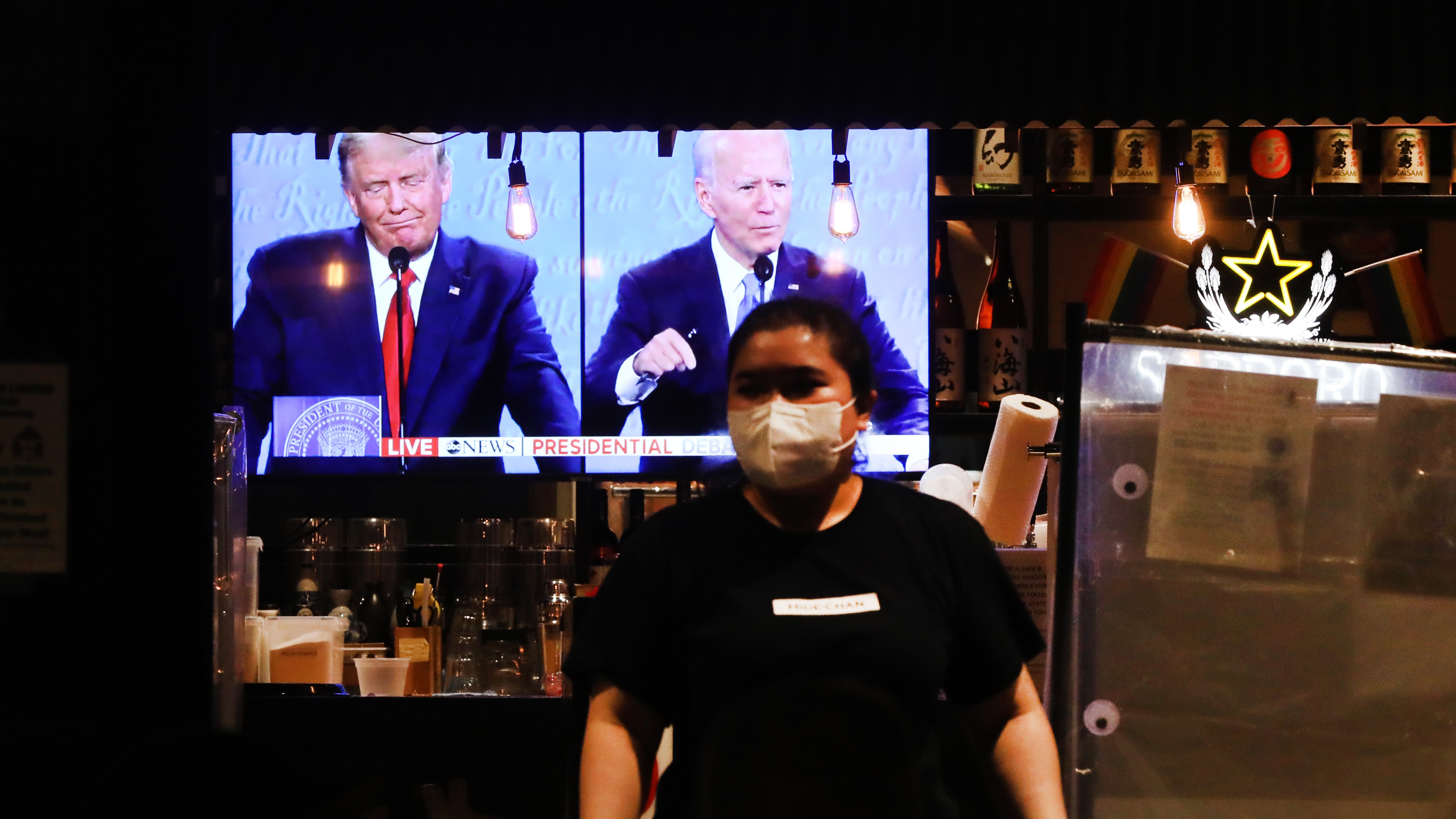 The final debate between President Donald Trump and Joe Biden plays on a restaurant television in Manhattan