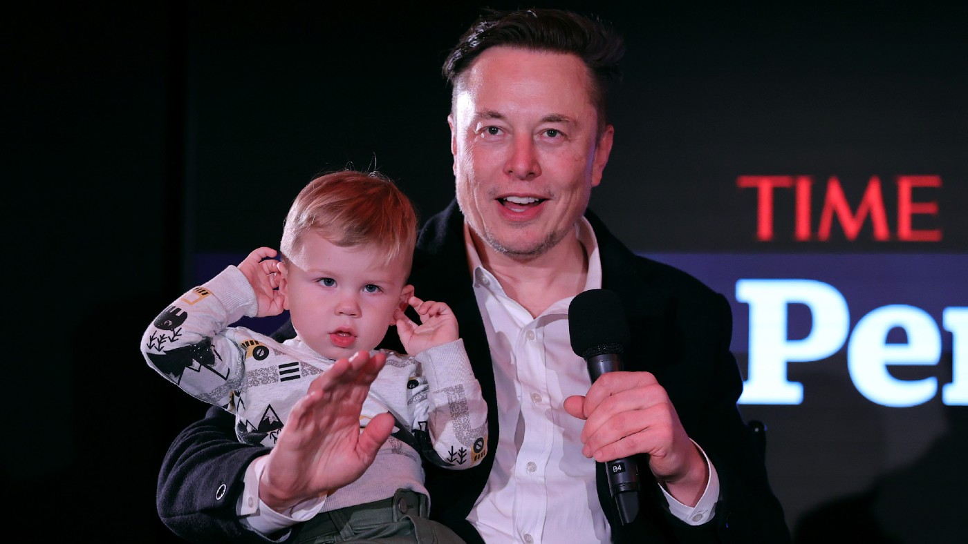 Elon Musk and son X Æ A-12 on stage