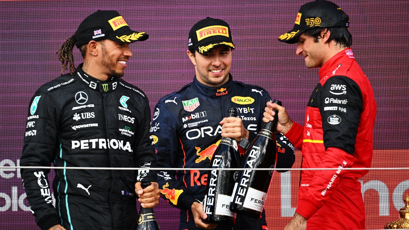 Lewis Hamilton, Sergio Pérez and race winner Carlos Sainz celebrate on the podium at Silverstone