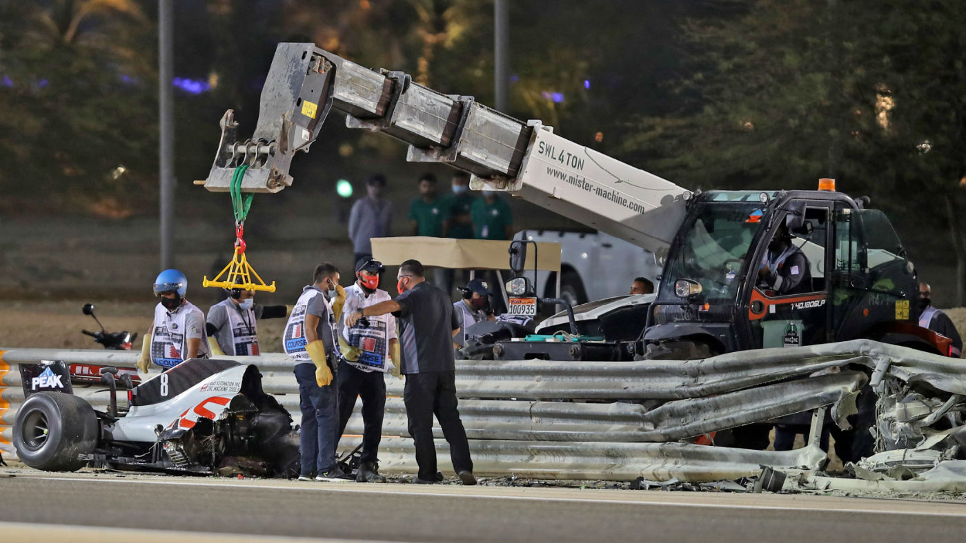 Stewards recover the Haas F1 car following Romain Grosjean’s crash at the Bahrain GP