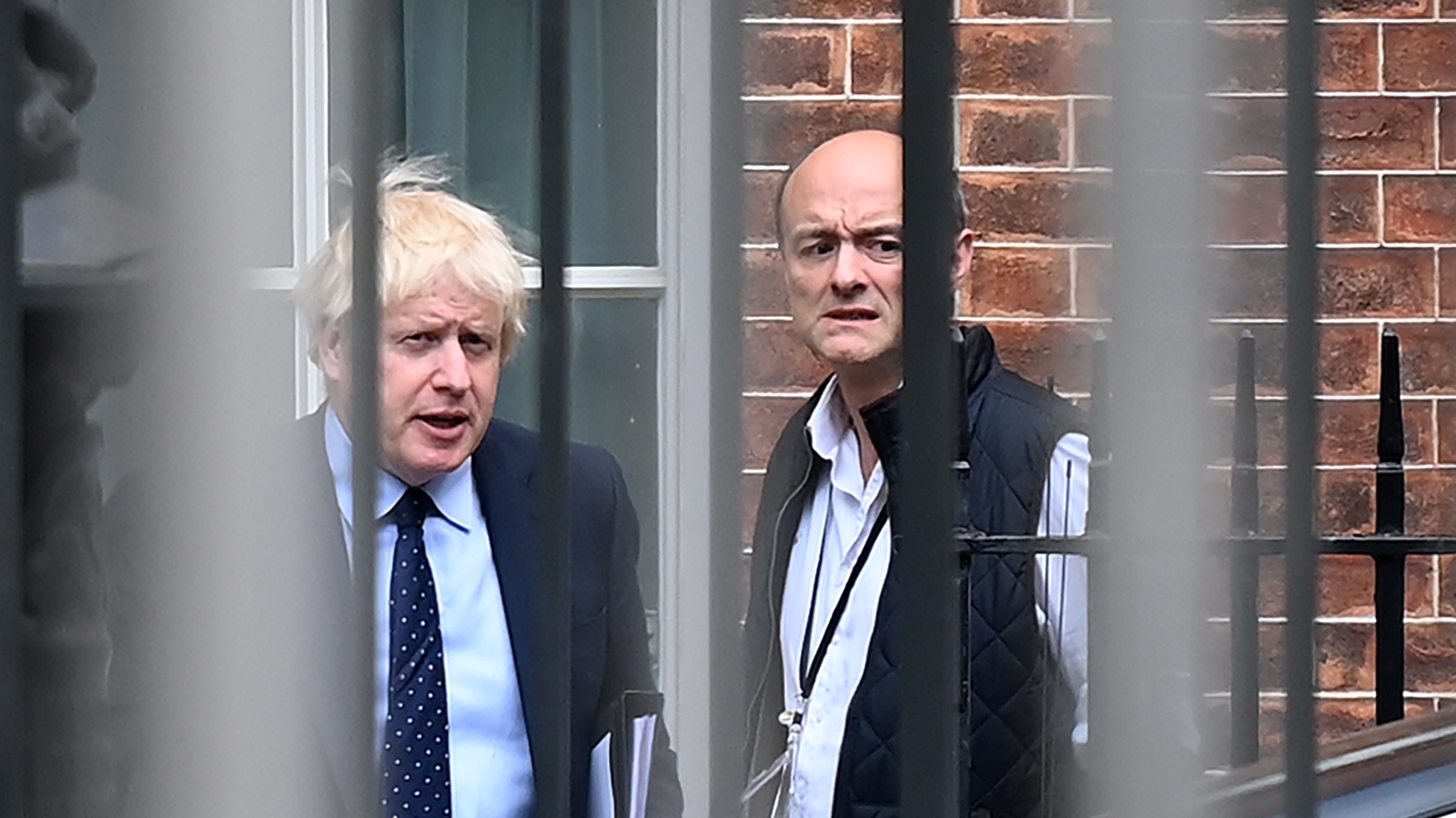 Boris Johnson and his former special advisor Dominic Cummings leave from the rear of Downing Street
