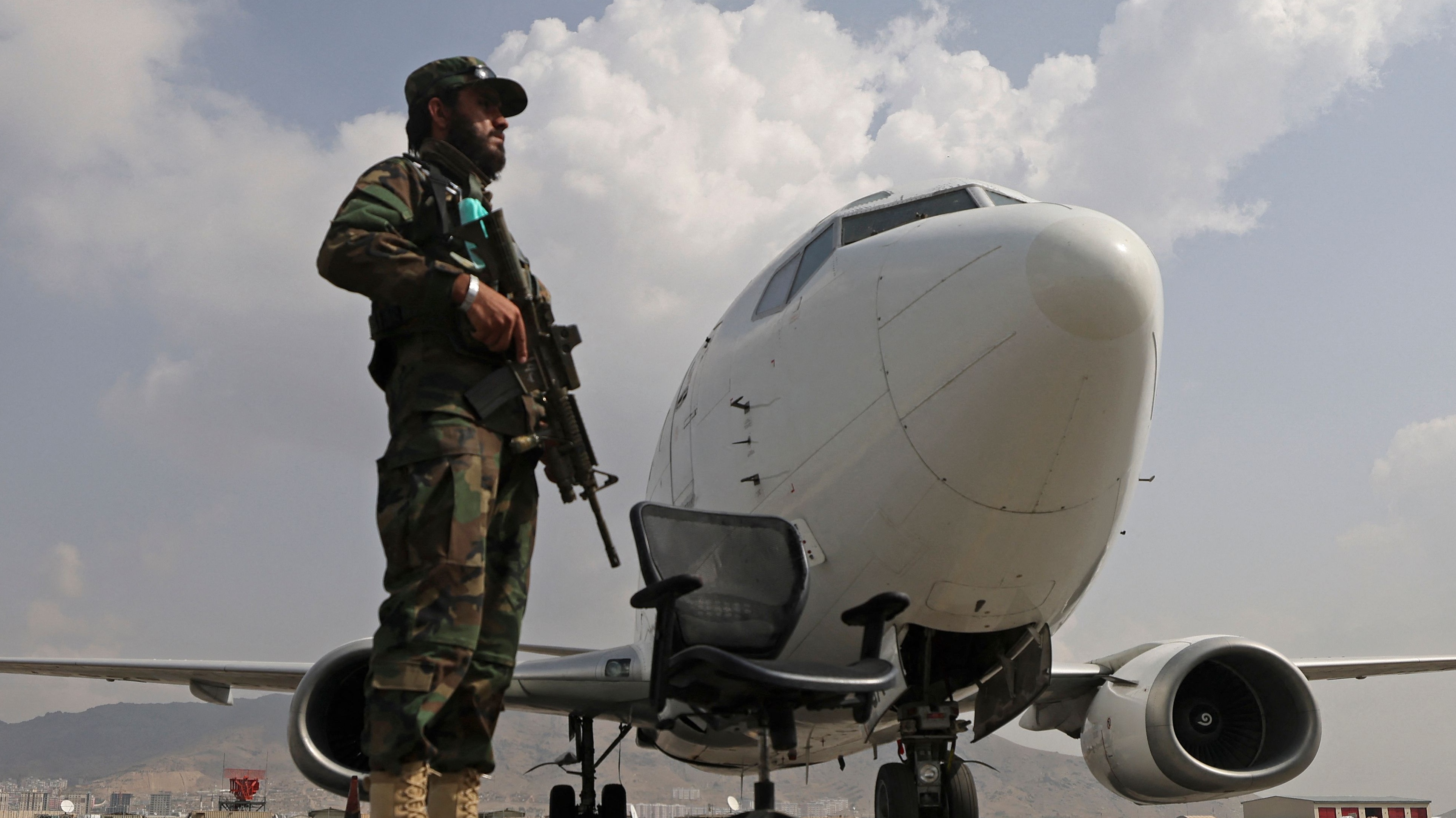 A Taliban fighter stands guard at Hamid Karzai International Airport in Kabul