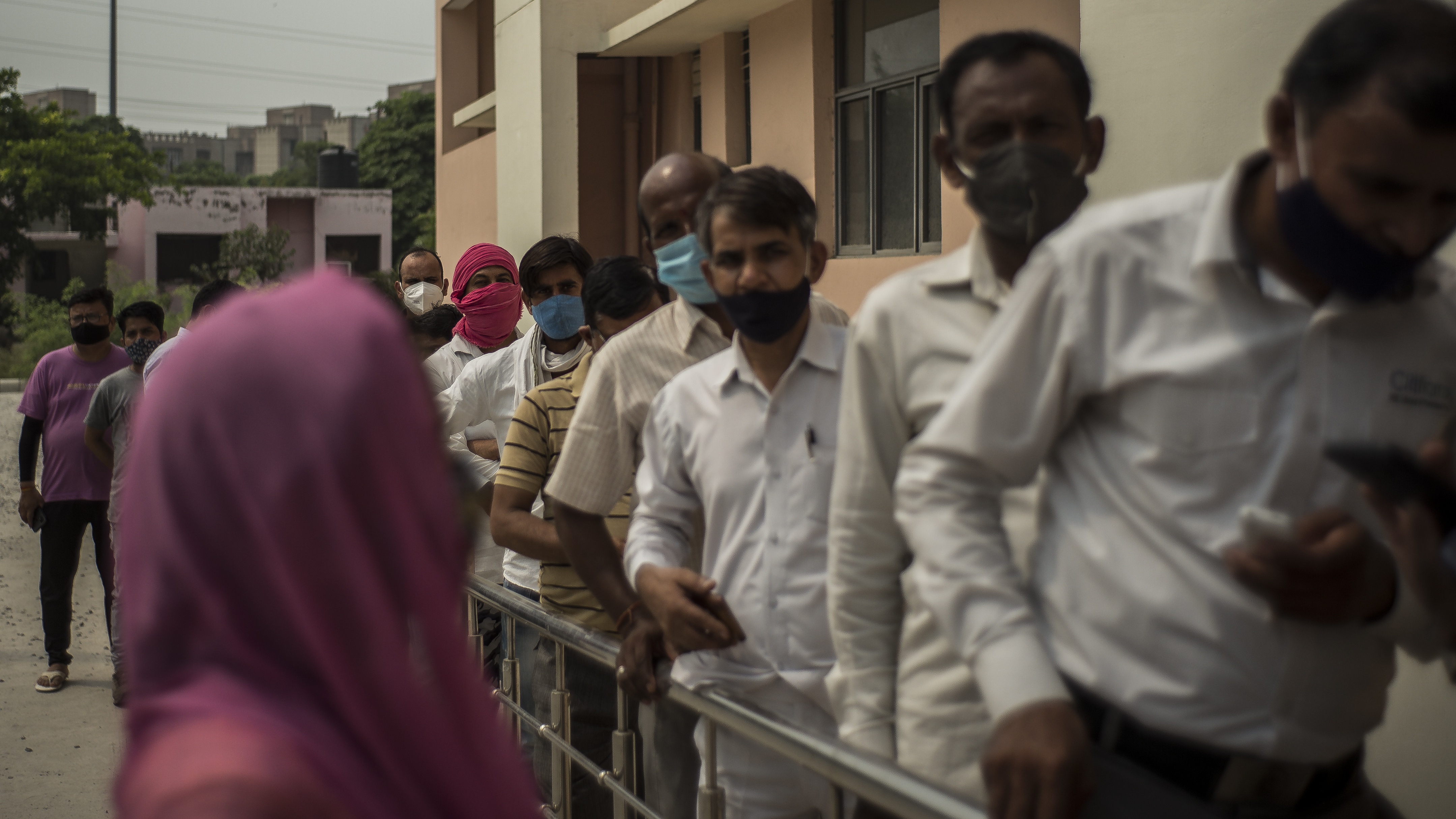 Patients queue for a vaccination in Noida, India