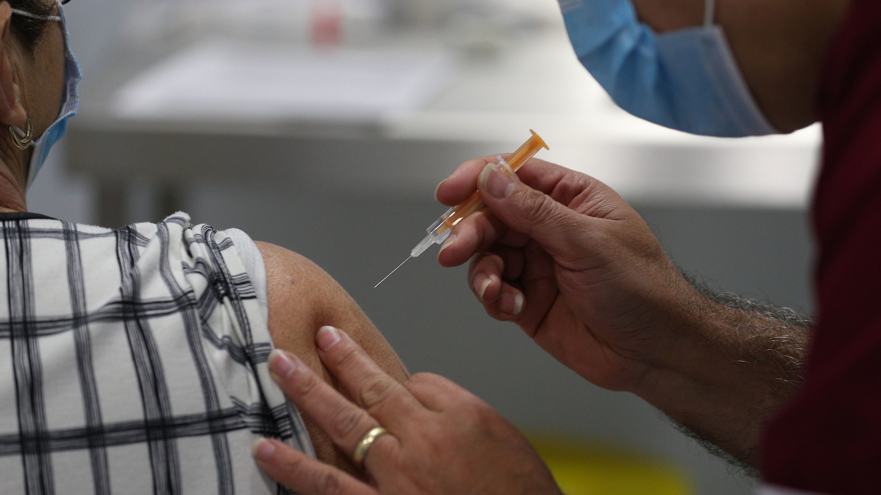 A patient receives a dose of the Oxford-AstraZeneca vaccine
