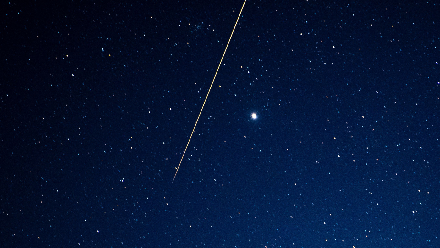 Asteroid flies through night sky